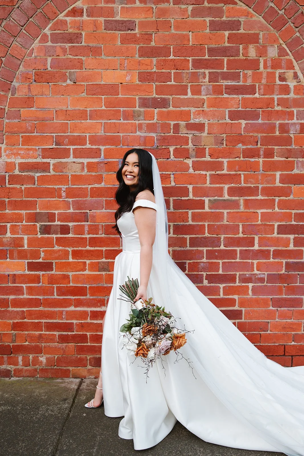 Bride on her wedding day with toffee rose bridal bouquet