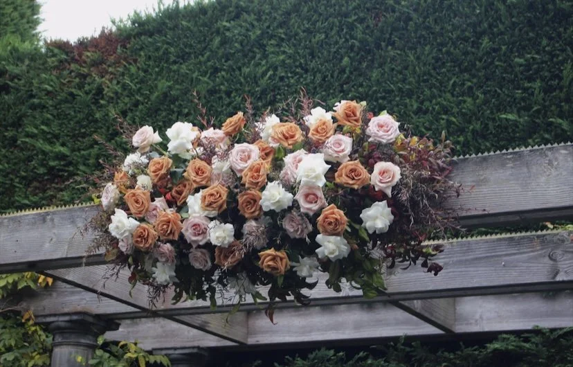Ceremony arch arrangement with toffee and quicksand roses at Quat Quatta