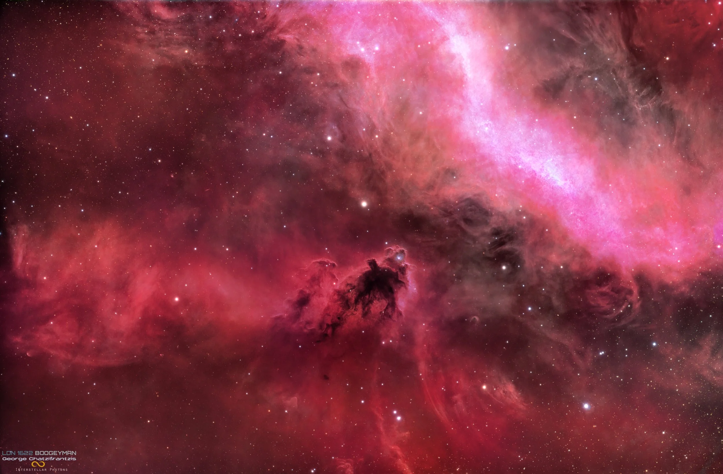 LDN 1622, the Boogeyman Nebula, appears as a dark, claw shaped cloud silhouetted against glowing red hydrogen emission and dense Milky Way star fields.