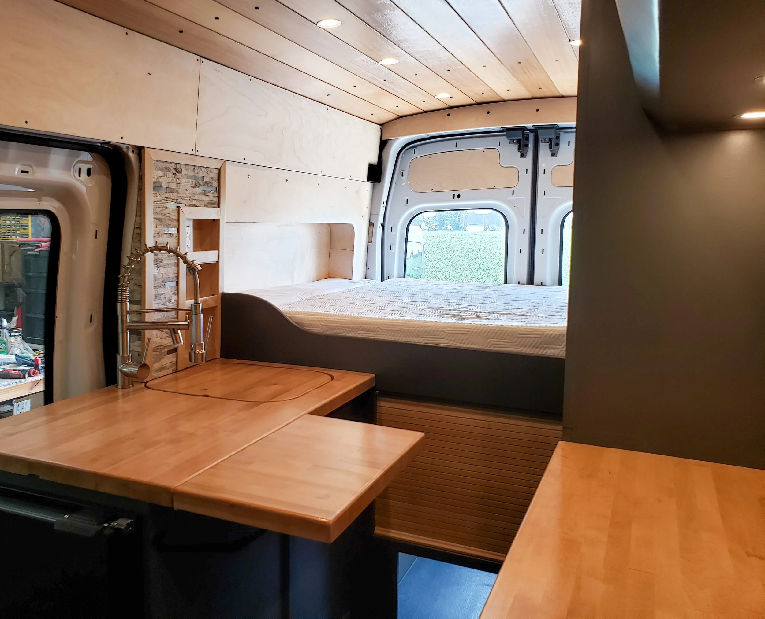 Kitchen, with fold-up countertop and refrigerator accessible from outside