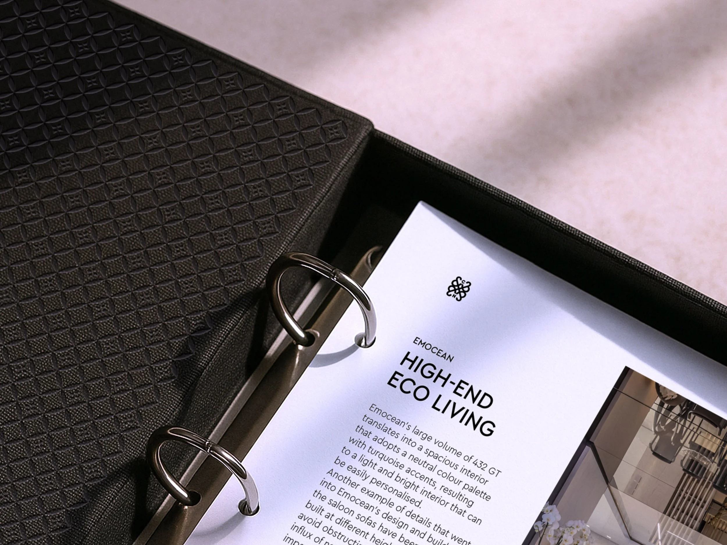 A close up of a C&N ring binder. The binder is black and has the Camper & Nicholsons pattern