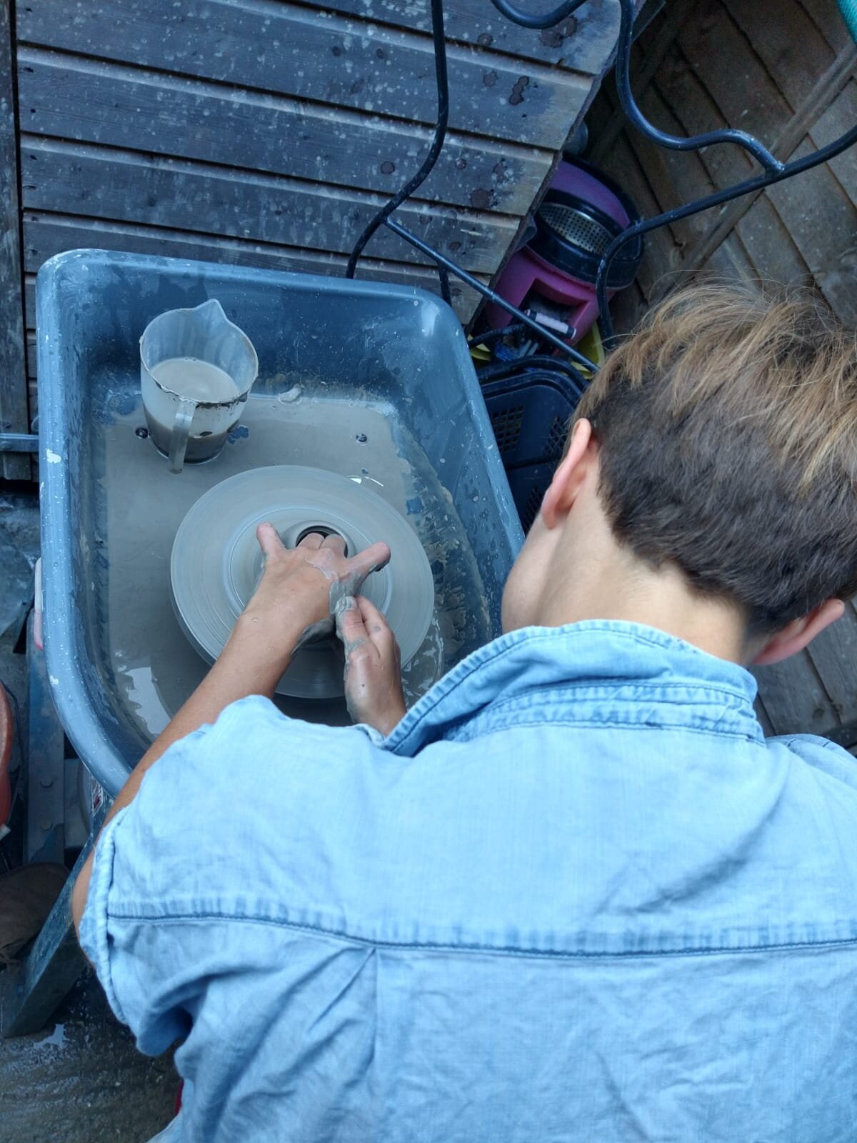 Throwing on the kick wheel