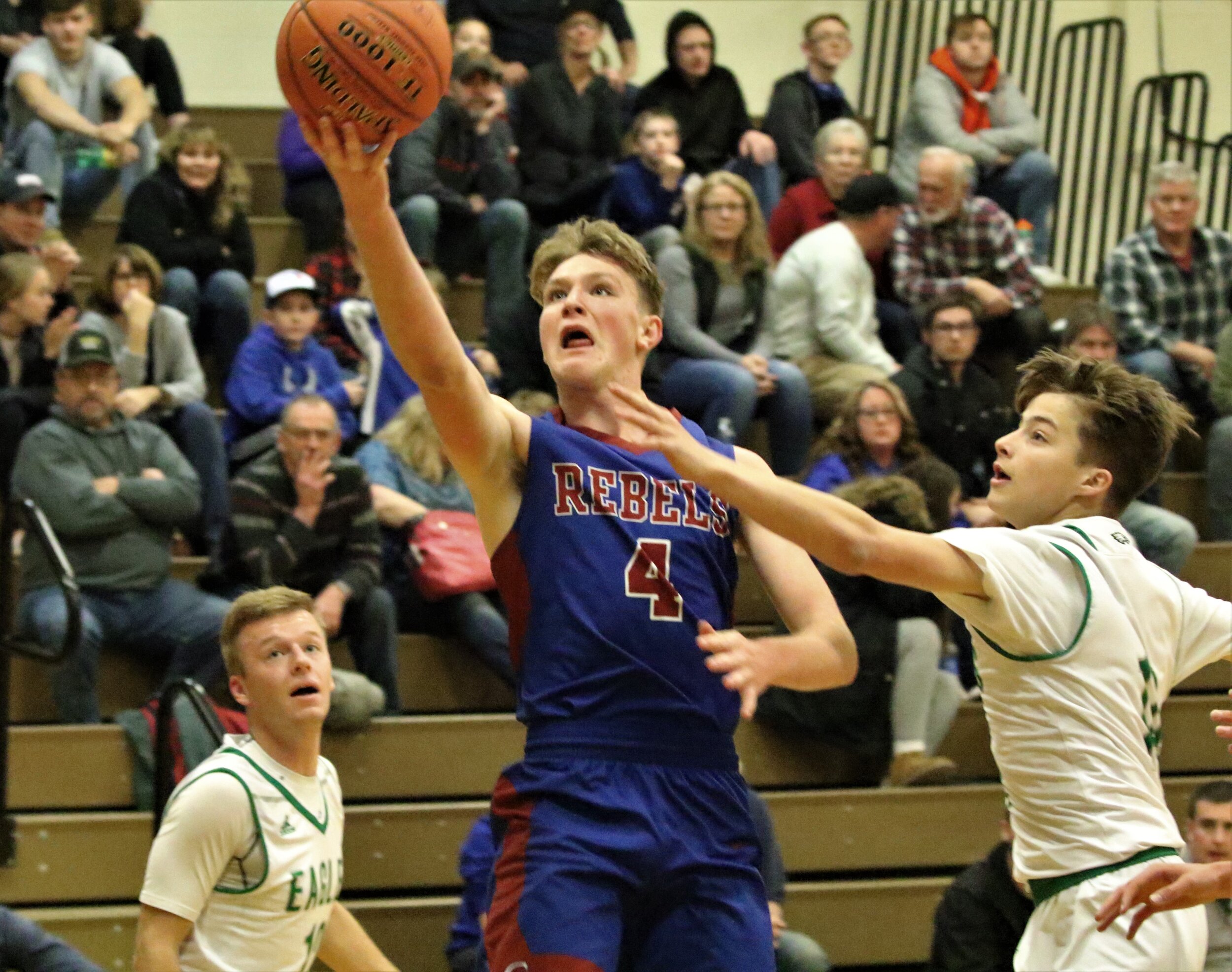  Cuba-Rushford senior Ethan Brooks (4) floats his way to the basket, as Fillmore senior Hayden Rust, right, looks to challenge during Friday’s road contest in Fillmore. [Chris Brooks/WellsvilleSports.com] 