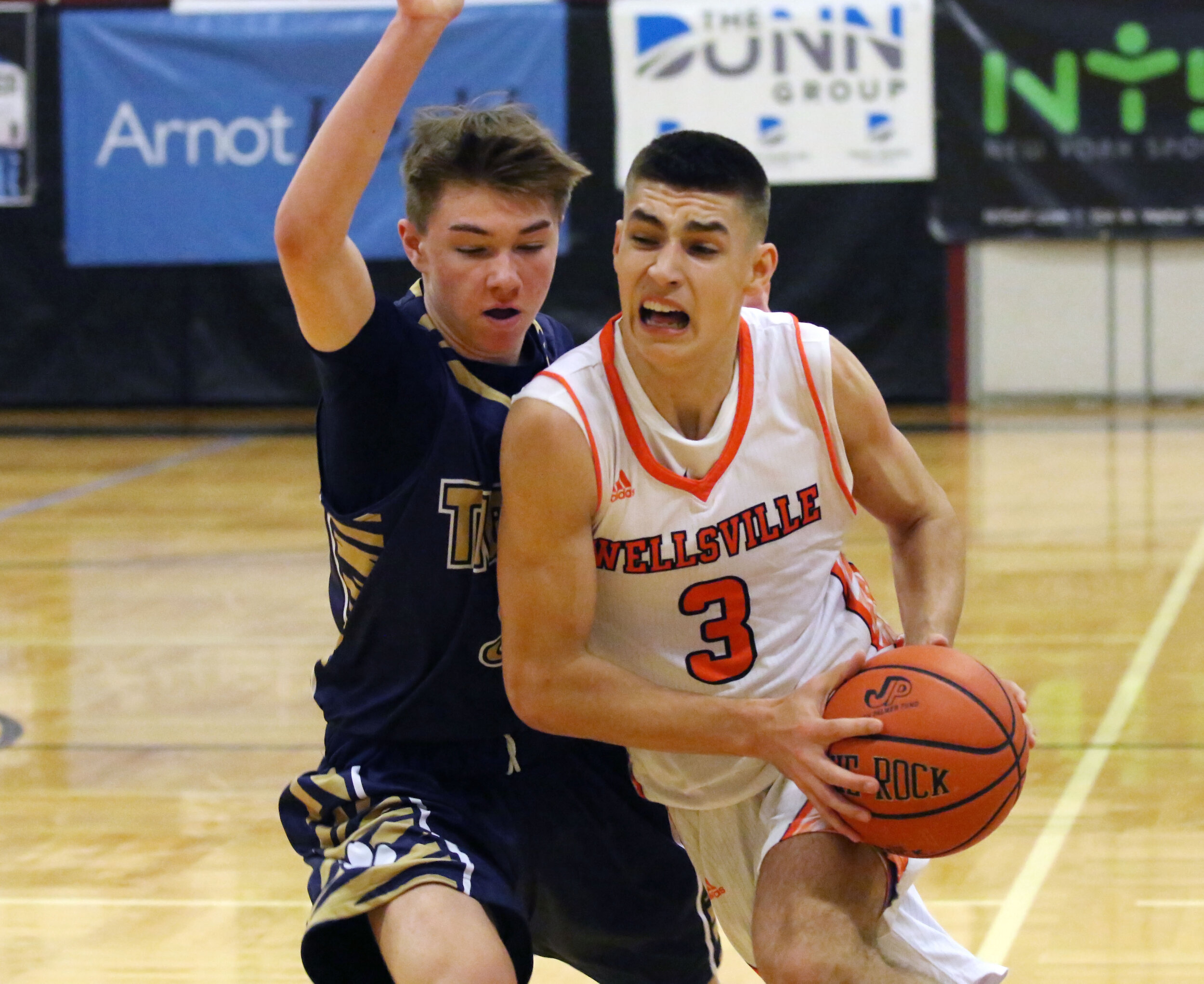  Wellsville senior Max Jusianiec (3) drives the lane against the North Penn-Mansfield defense during Monday afternoon’s championship game of the Josh Palmer Holiday Classic in Elmira. [Chris Brooks/WellsvilleSports.com] 