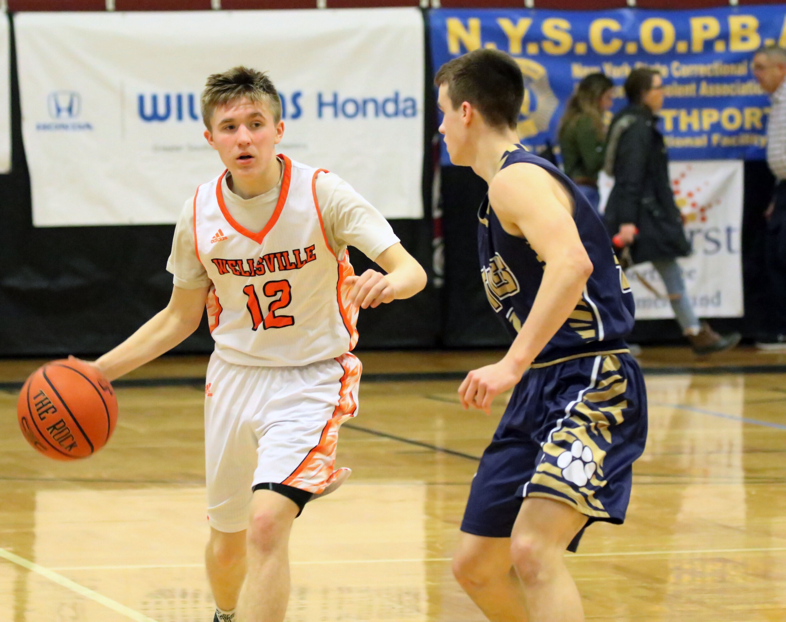  Wellsville junior Liam McKinley (12) looks to find his way around the North Penn-Mansfield defense during Monday afternoon’s championship game of the Josh Palmer Holiday Classic in Elmira. [Chris Brooks/WellsvilleSports.com] 