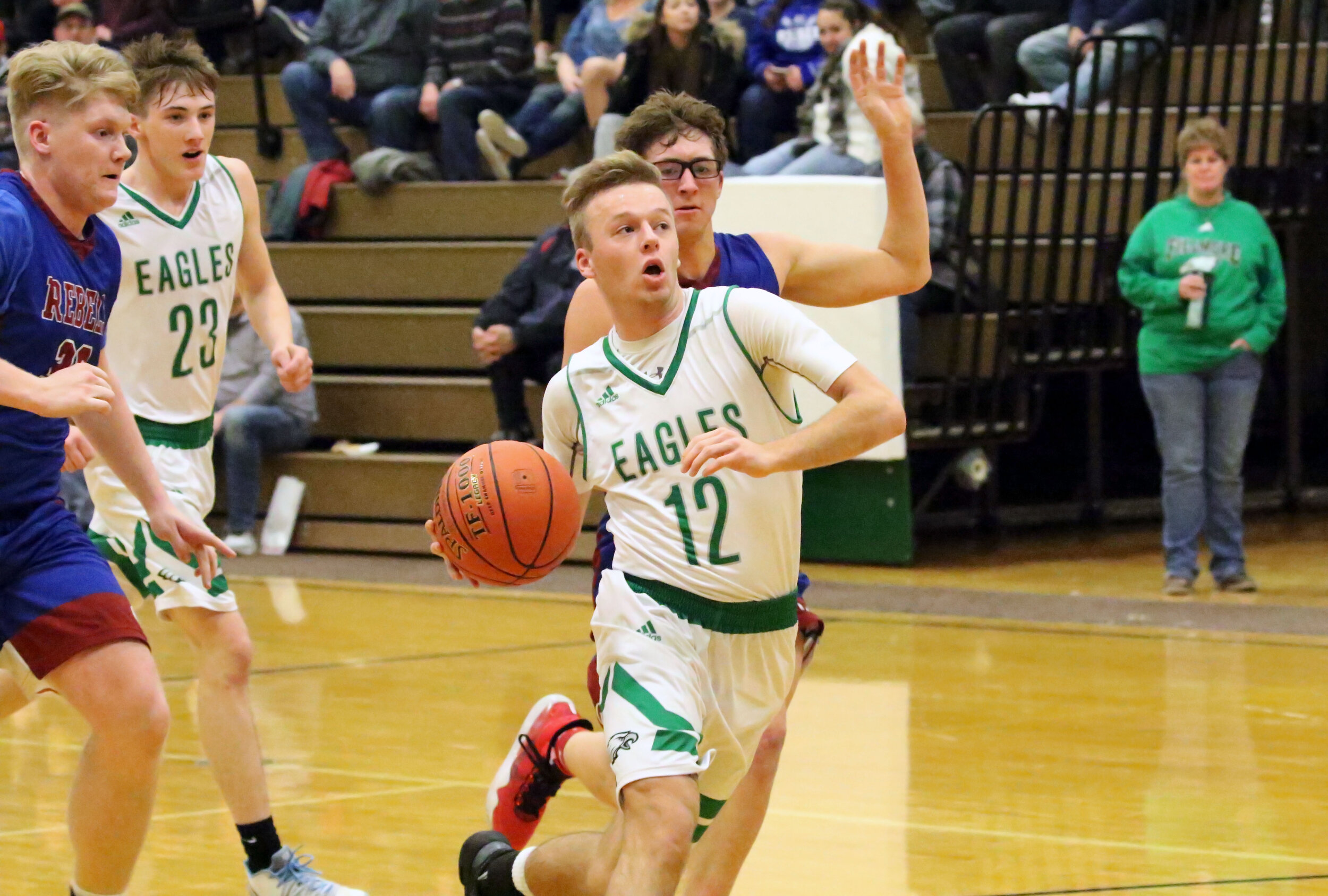  Fillmore senior Levi Webb (12) pushes the pace downcourt as Cuba-Rushford’s Grady McCumiskey, left, and Trent Chamberlain, back, look to contest during their matchup earlier this season. The Eagles are one of two Allegany County’s newest additions t