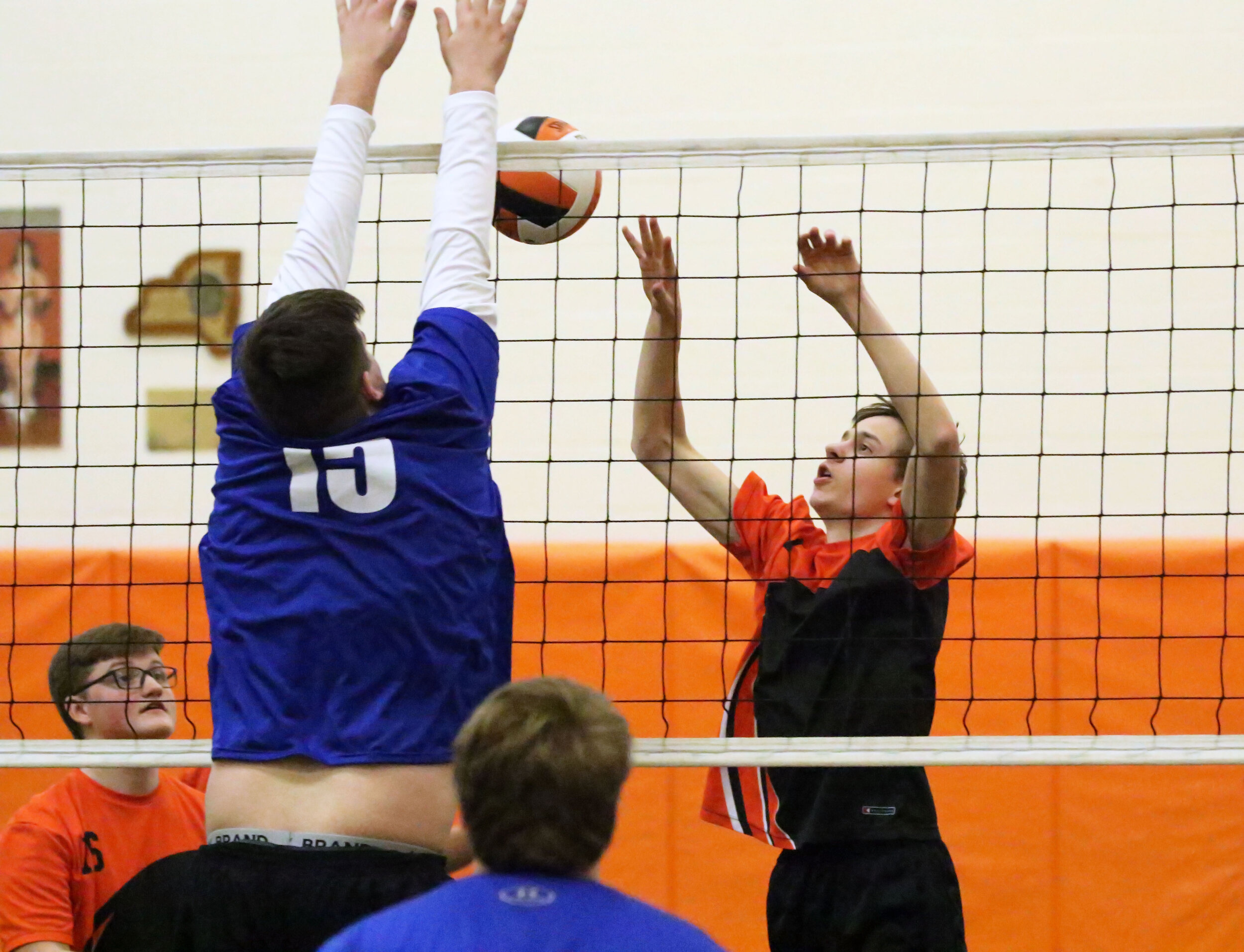 Wellsville’s Aiden Tucker, right, challenges the ball as Cuba-Rushford’s Devin Tullar (15) leaps up to make the denial during Thursday night’s home clash. [Chris Brooks/WellsvilleSports.com] 
