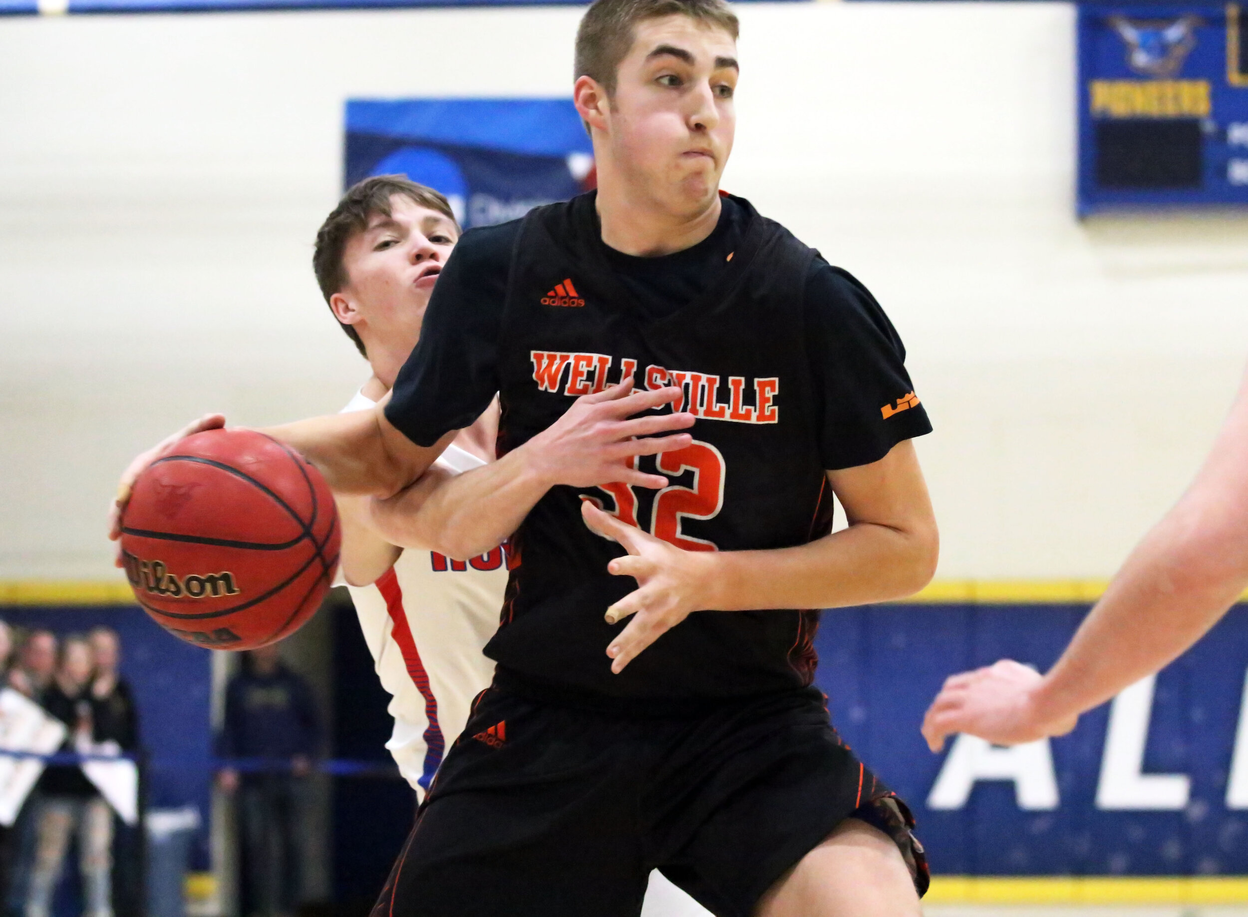  Wellsville junior Aidan Hart, middle, works his way past the Hornell defense on his way to the basket during Friday night’s clash with Hornell at the Barkley Showcase at Alfred State College. [Chris Brooks/WellsvilleSports.com] 