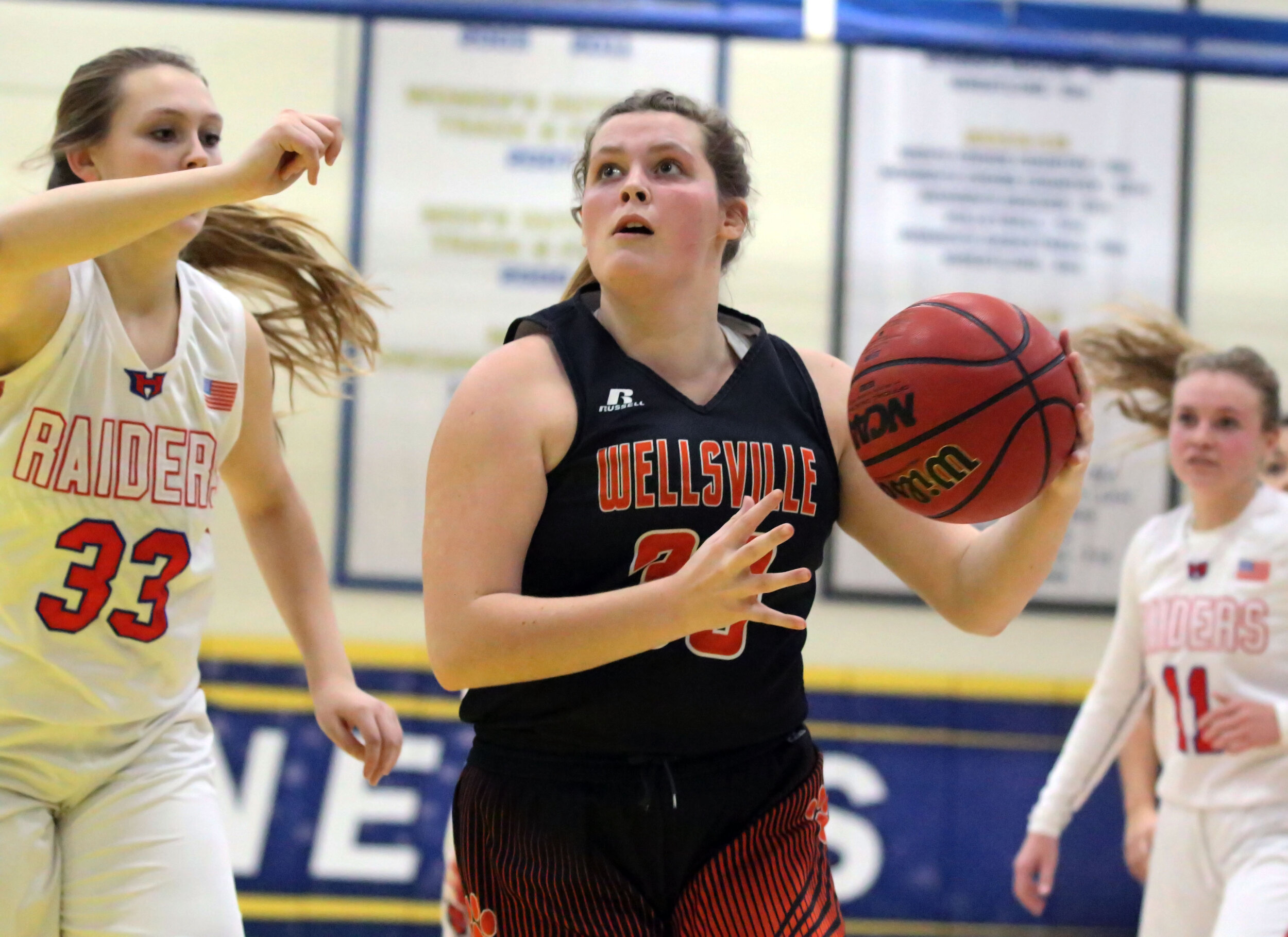  Wellsville senior Regan Marsh, middle, drives her way to the basket as the Hornell defense defends alongside during Friday night’s clash at the Barkley Showcase at Alfred State College. [Chris Brooks/WellsvilleSports.com] 