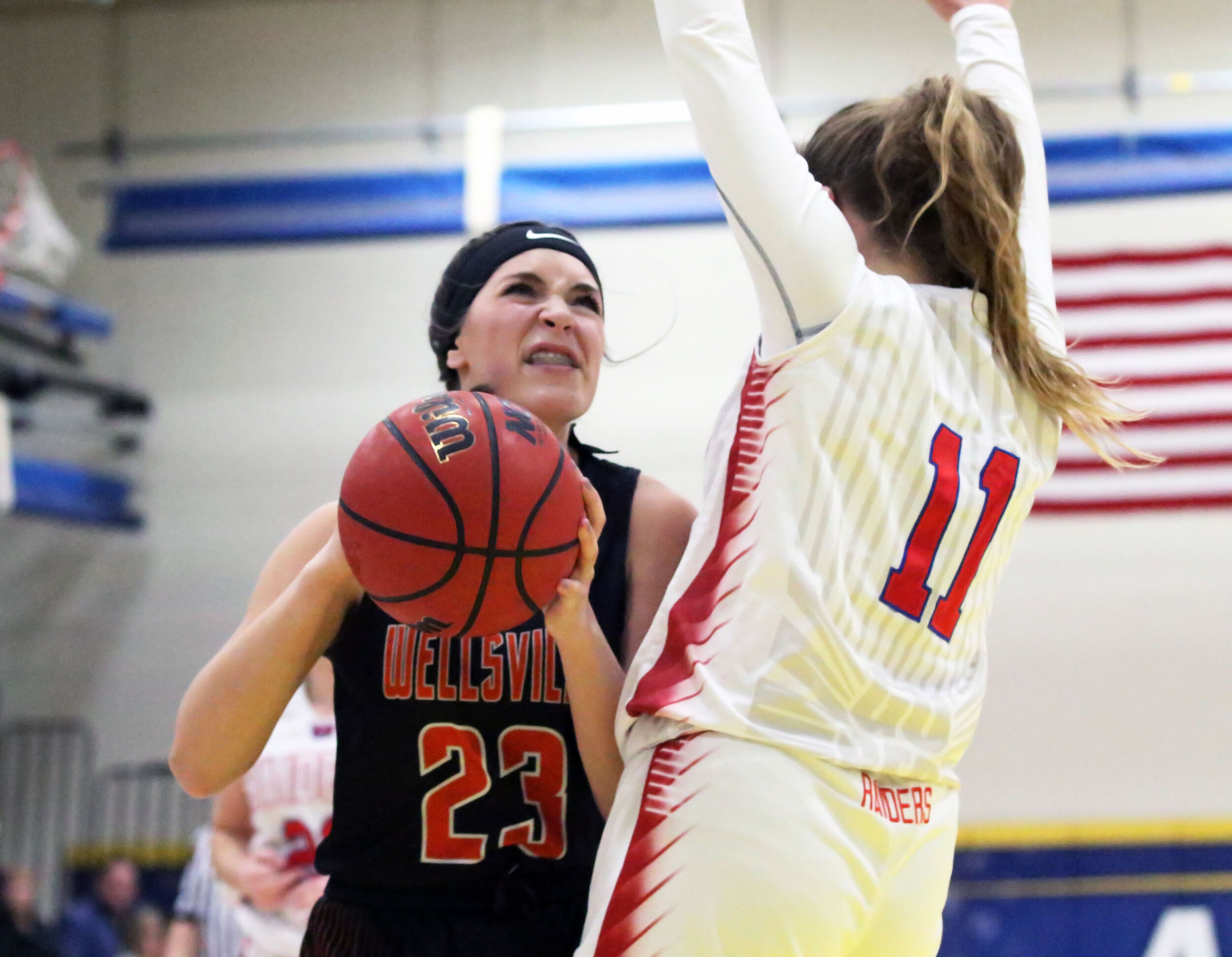  Wellsville sophomore Kaylee Coleman (23) looks to power her way to the basket against the Hornell defense during Friday night’s clash at the Barkley Showcase at Alfred State College. [Chris Brooks/WellsvilleSports.com] 