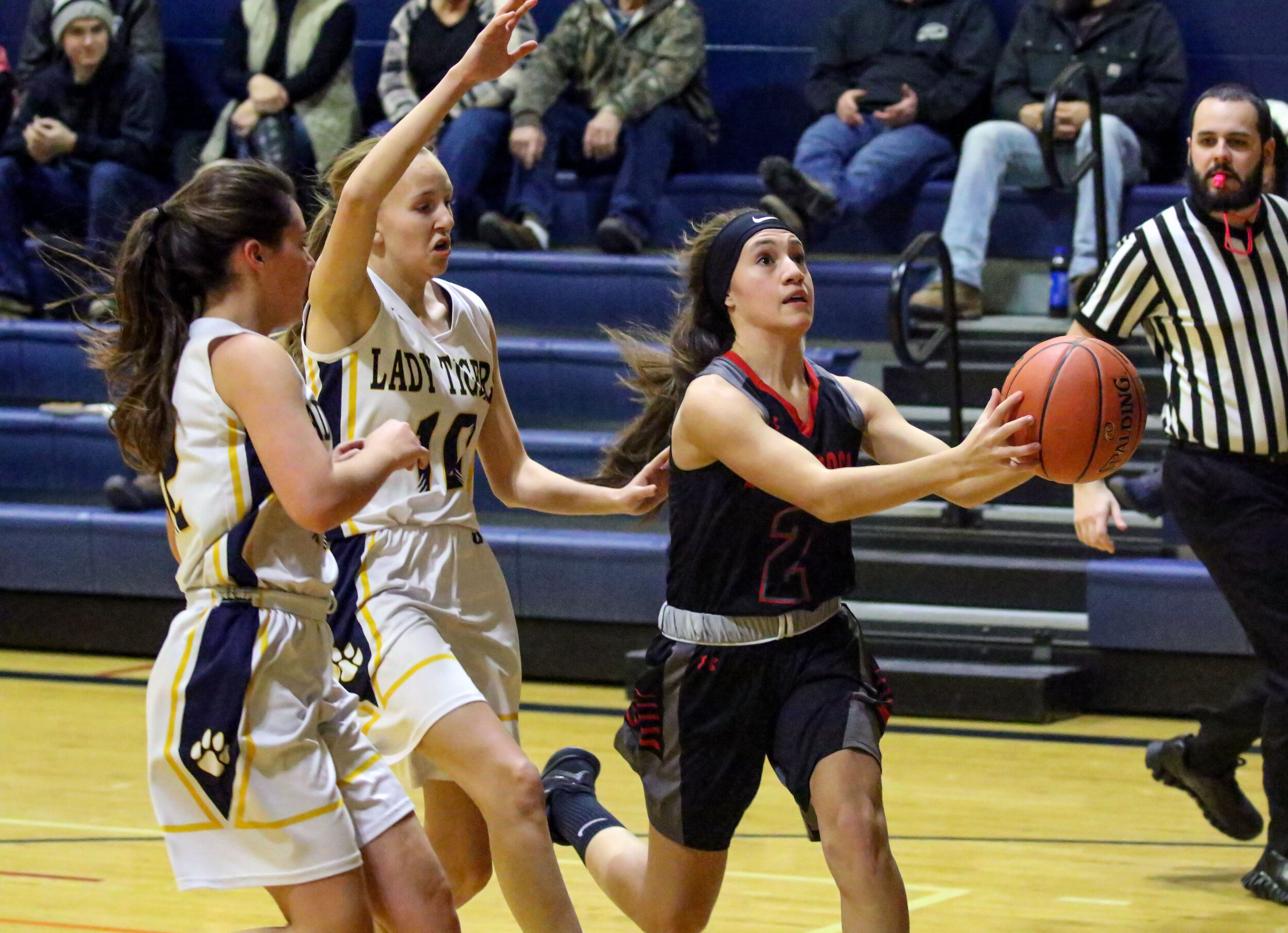  Belfast sophomore Alicia Borden (2) drives past the Scio defense of senior Ashlynn Scotchmer (10), and junior Camryn Wiech, left, on the way to the basket during Friday night’s road contest in Scio. [Chris Brooks/WellsvilleSports.com] 