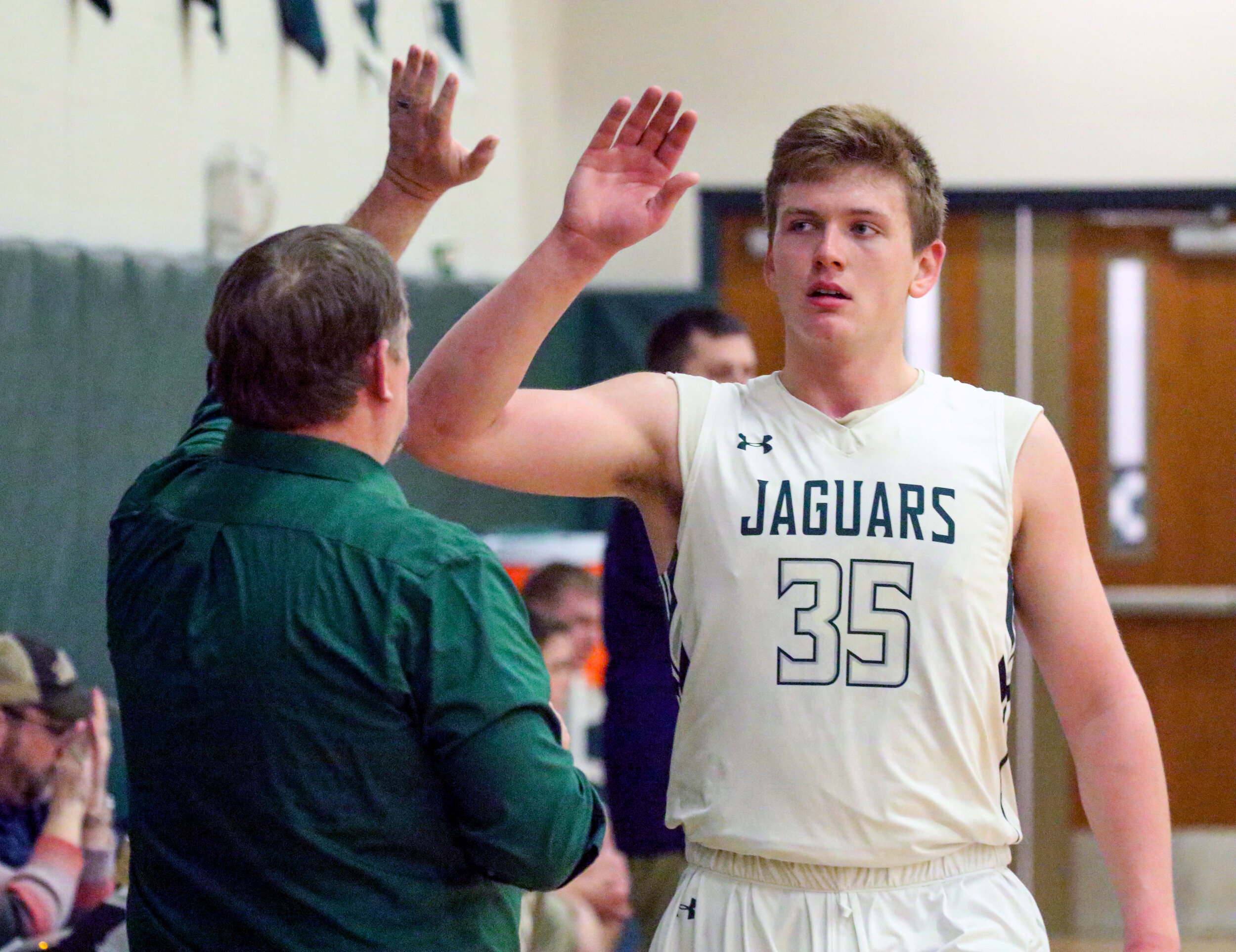  Genesee Valley senior Cody Schneider (35) receives a high-five from head coach Lintz Bliven on his return to the bench during Friday night’s 76-38 Senior Night victory over the visiting Scio Tigers, in Belmont. [Chris Brooks/WellsvilleSports.com] 