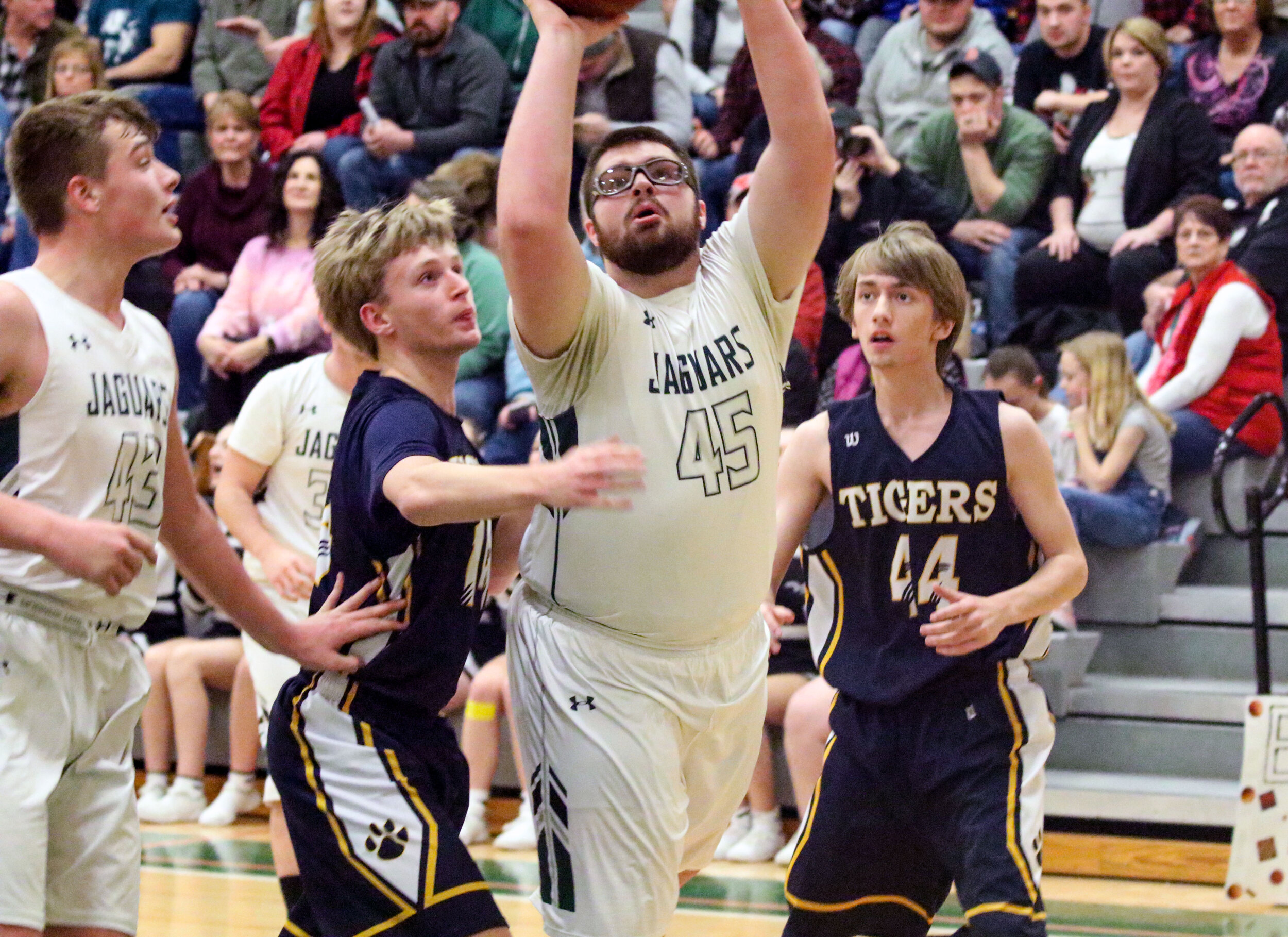  Genesee Valley junior Cody Platt (45) digs his way past the Scio defense of senior Alex Field, left, and senior Tristen Woodruff (44) on his way to the basket during Friday night’s home finale in Belmont. [Chris Brooks/WellsvilleSports.com] 