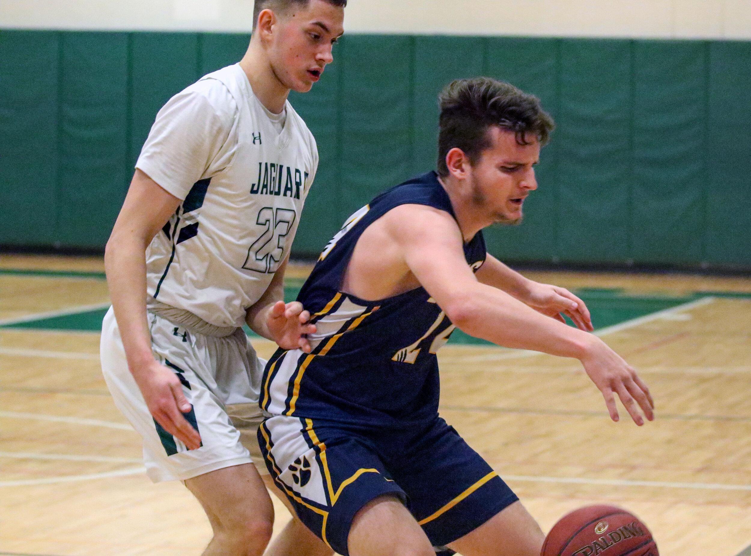  Scio senior Brendan Graves, off-center, looks to control his dribble while working against the defense of Genesee Valley junior Brock Ellsessor (23) during Friday night’s road contest in Belmont. [Chris Brooks/WellsvilleSports.com] 