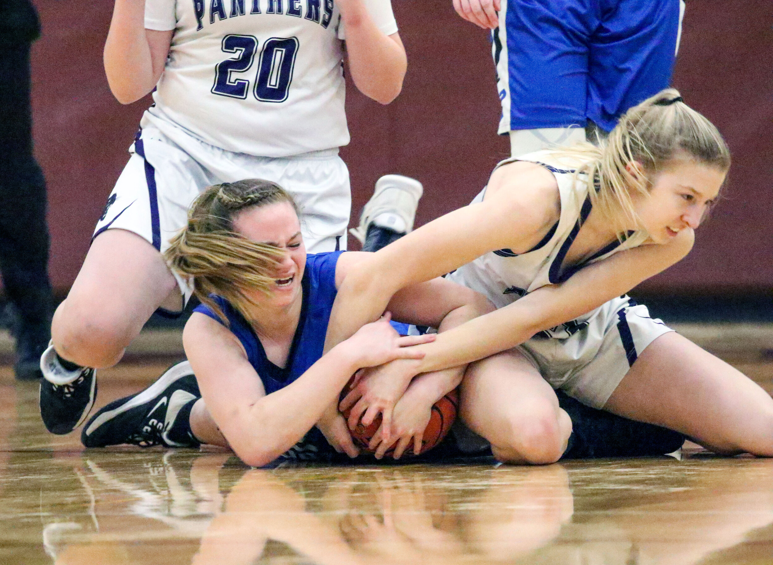  Whitesville junior Kate Pensyl, off-center, and Andover junior Kelsie Niedermaier, right, tangle over the loose ball during Monday night’s Class D2 Semifinal contest at Wayland-Cohocton. [Chris Brooks/WellsvilleSports.com] 