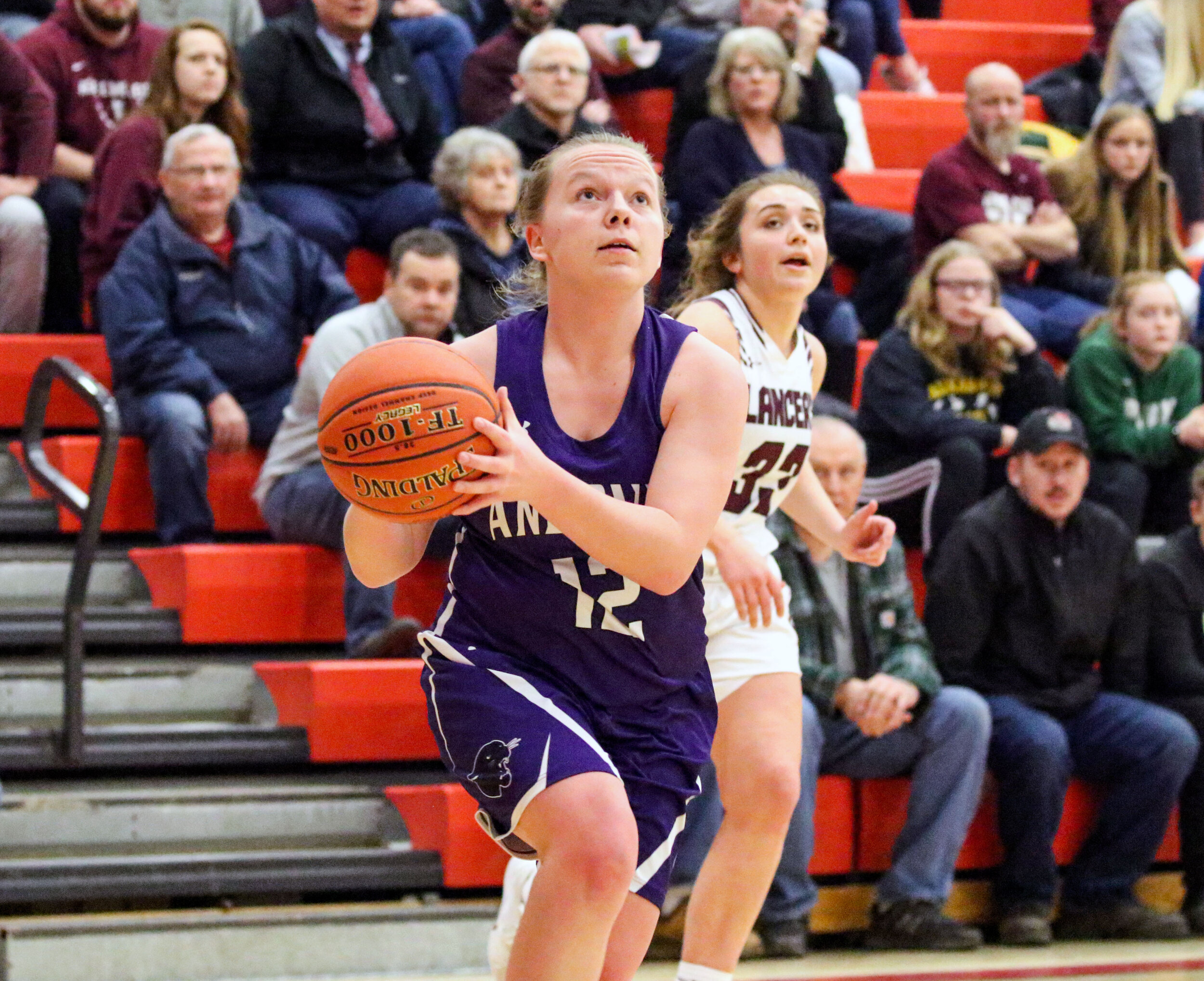  Andover senior Katie Calladine (12) drives the baseline on her way to the basket against the Elba defense in front during Friday night’s Class D2 Finals contest at Letchworth. [Chris Brooks/WellsvilleSports.com] 