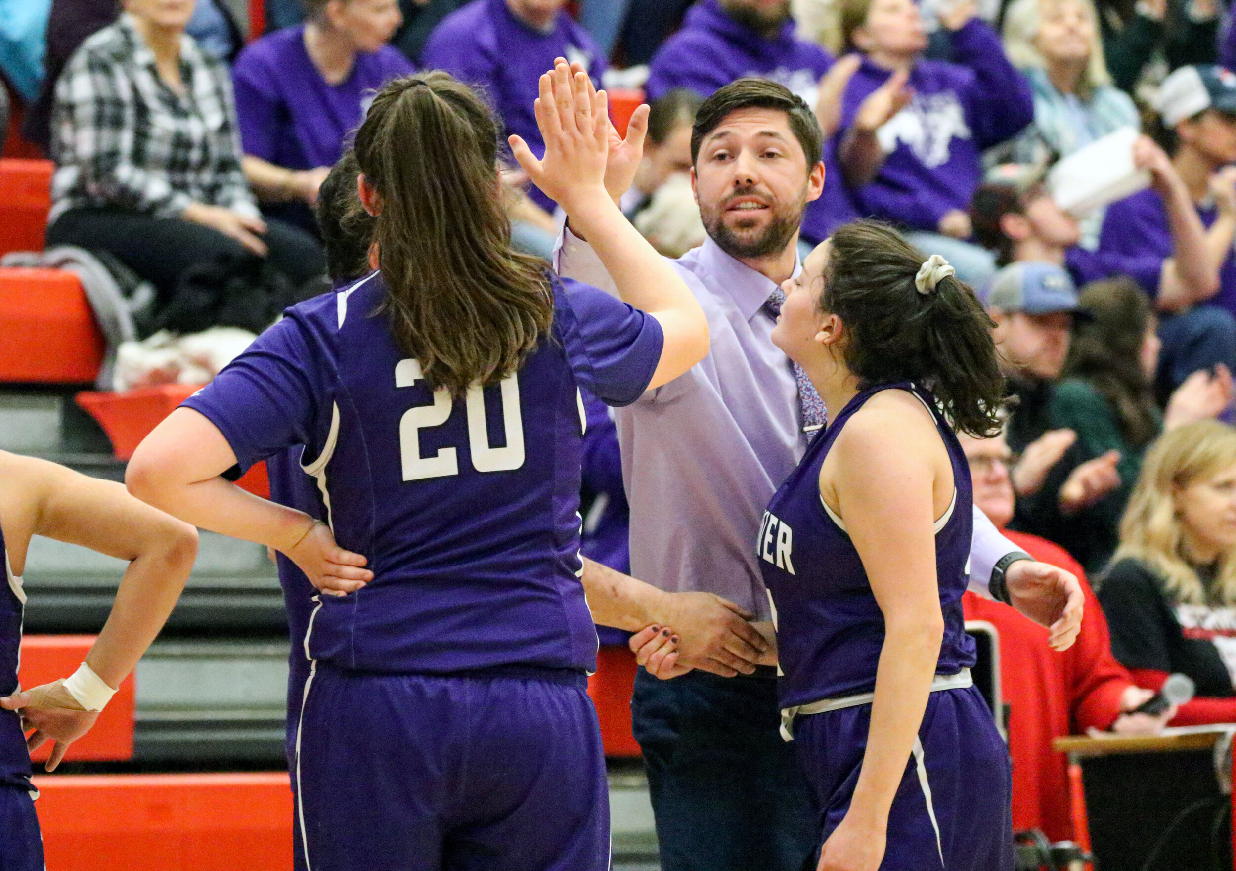  Andover head coach Jake Bannerman, off-center, hands out a high-five to junior Livia Simon (20) upon returning to the bench during a break in the action of Friday night’s Class D2 Finals contest against Elba, at Letchworth. [Chris Brooks/WellsvilleS