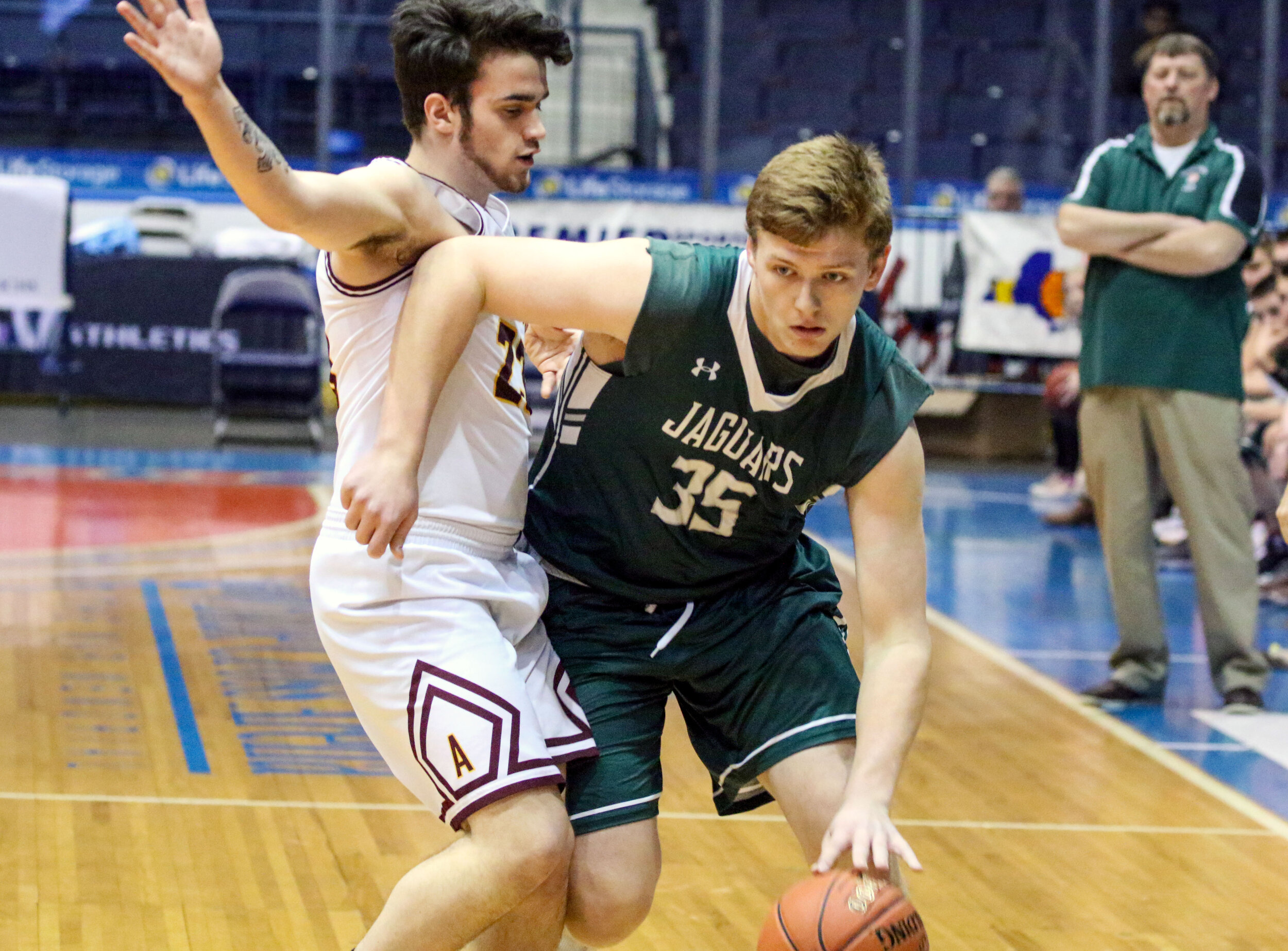  In this file photo, Genesee Valley senior Cody Schneider (35) looks to work around the Avoca defense along the sideline during their Class D1 Finals matchup at Blue Cross Arena this past winter. Schneider, along with Evan Windus and Brock Ellsessor,