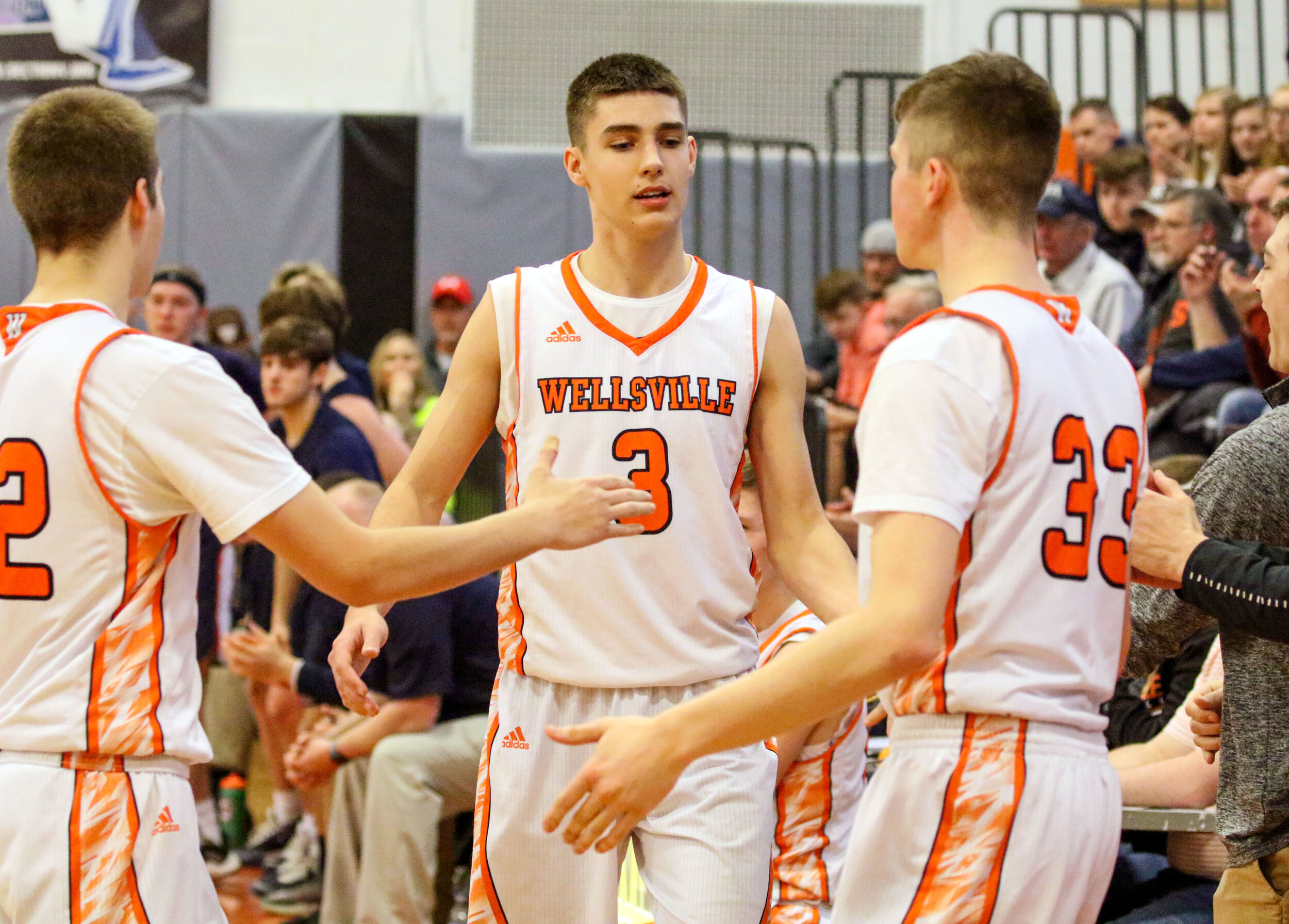  In this file photo, Wellsville senior Max Jusianiec (3) makes his way to the bench while being congratulated by his teammates Aidan Hart, left, and Brayden Delahunt (33) after the team’s Quarterfinal victory over Mynderse in Sectionals this past sea