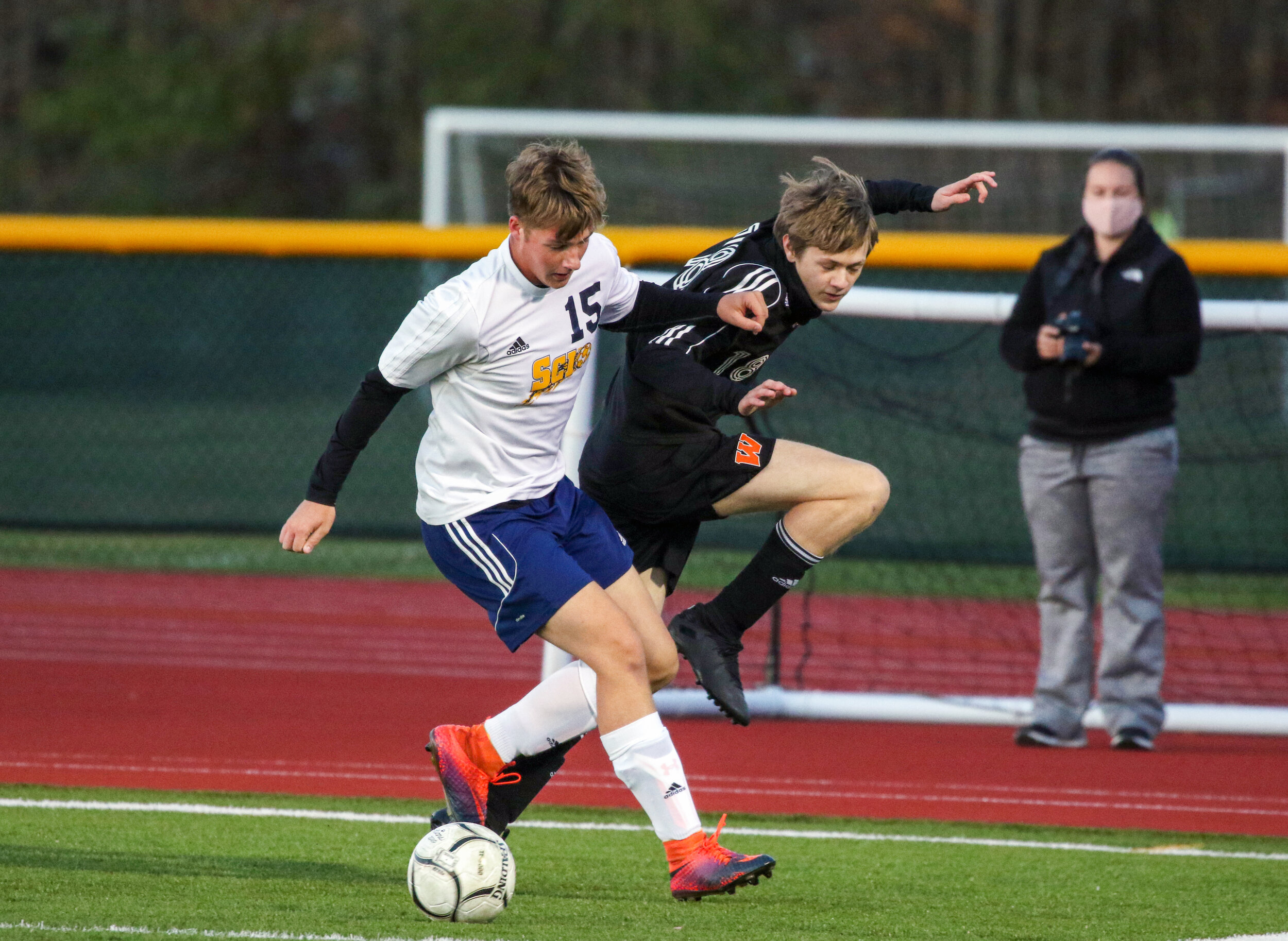  Scio junior Carter Silsby (15) and Wellsville sophomore Aidan Riley, right, battle for the loose ball just outside the box during Friday night’s contest in Wellsville. [Chris Brooks/WellsvilleSports.com] 