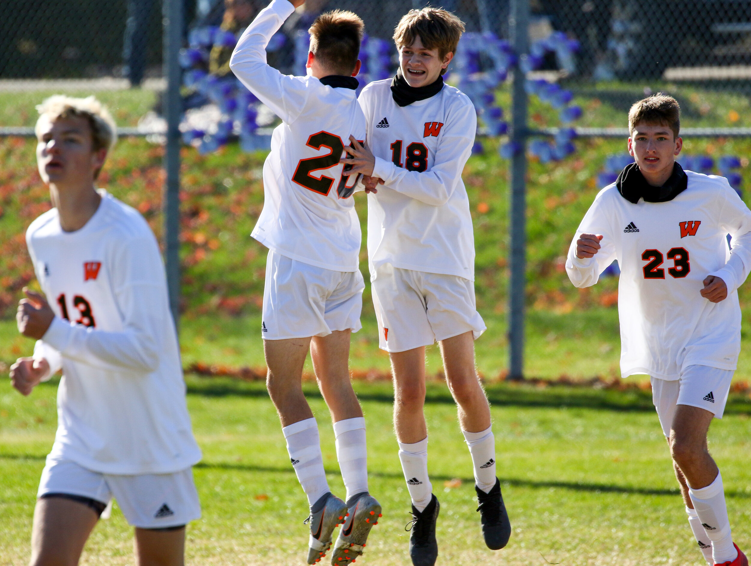  Wellsville sophomore Aidan Riley (18) celebrates with teammate Cody Costello (20) after scoring the first goal of their Saturday afternoon contest in Andover. [Chris Brooks/WellsvilleSports.com] 