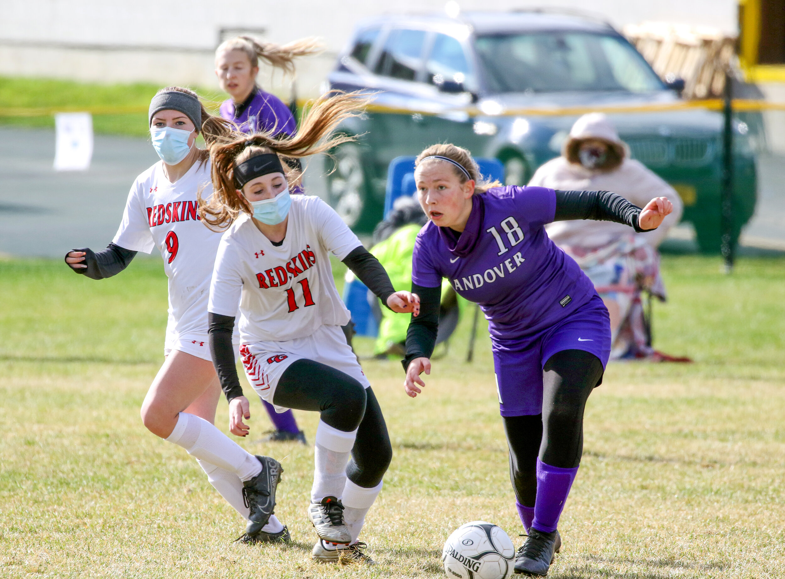  Andover/Whitesville sophomore Kennedy Bledsoe (18) surveys the field with possession of the ball, as Canisteo-Greenwood freshman Lillian Mullen (11) defends during Saturday afternoon’s contest in Andover. [Chris Brooks/WellsvilleSports.com] 