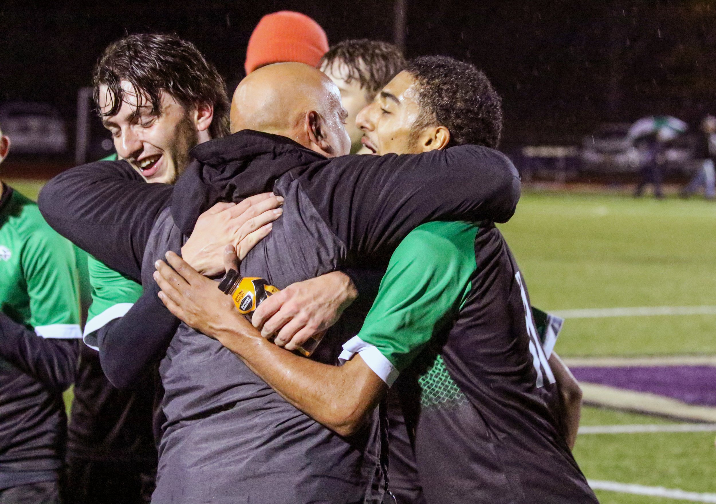  In this file photo, Fillmore head coach Jamie Mullen shares an embrace with both seniors Graham Cahill, left, and Deen Muzaid-Omar, right, after winning the Section V, Class D1 Championship back in October. Mullen’s Hall of Fame career with Fillmore
