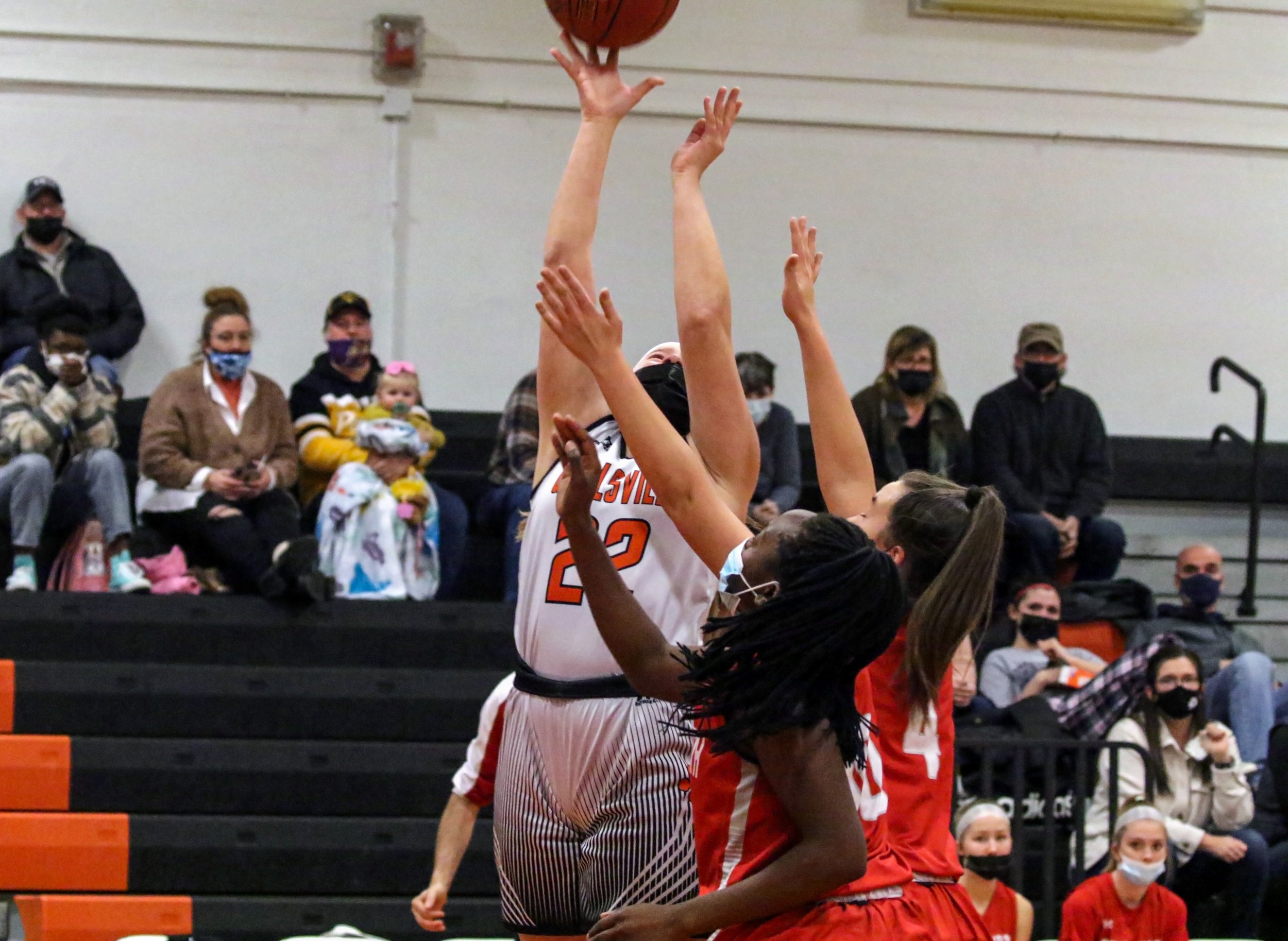  Wellsville junior Sara Reitz (22) goes up for the basket while under pressure from the Letchworth defense during Saturday night’s home contest in Wellsville. [Chris Brooks/WellsvilleSports.com] 