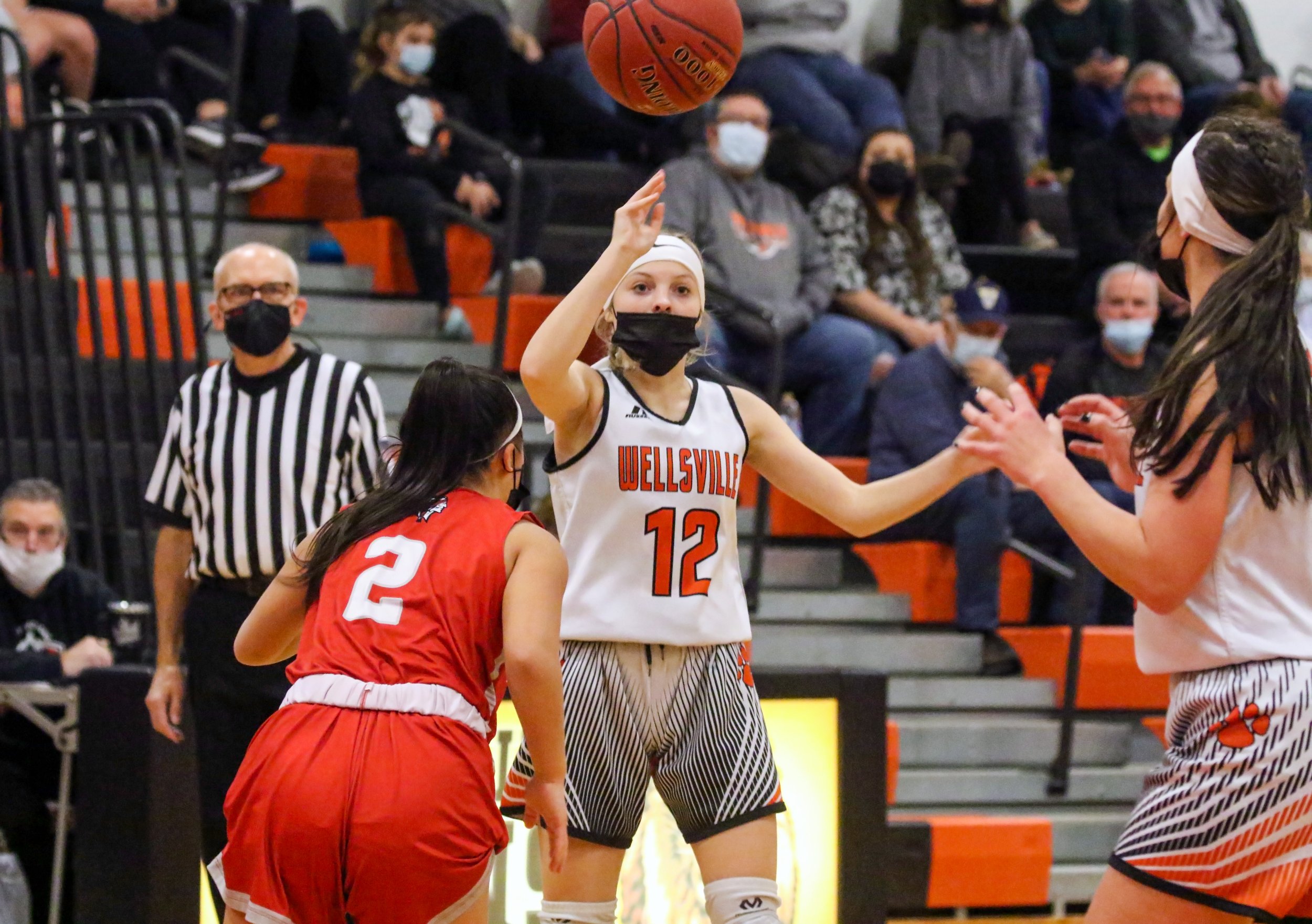 Wellsville senior Emily Costello (12) provides a pass to a streaking Kaylee Coleman, far right, on her way to the basket during Saturday night’s home contest against Letchworth. [Chris Brooks/WellsvilleSports.com] 