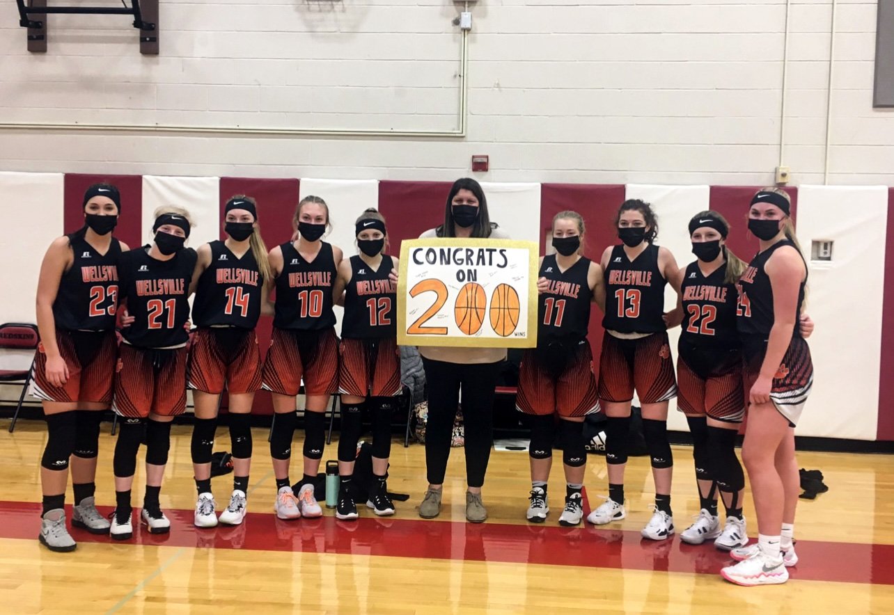  The Lady Lions of Wellsville come together alongside their head coach, Michelle Alvord, middle, who picked up career victory No. 200 after the team defeated Canisteo-Greenwood over the road on Tuesday, in Canisteo. [PHOTO PROVIDED] 
