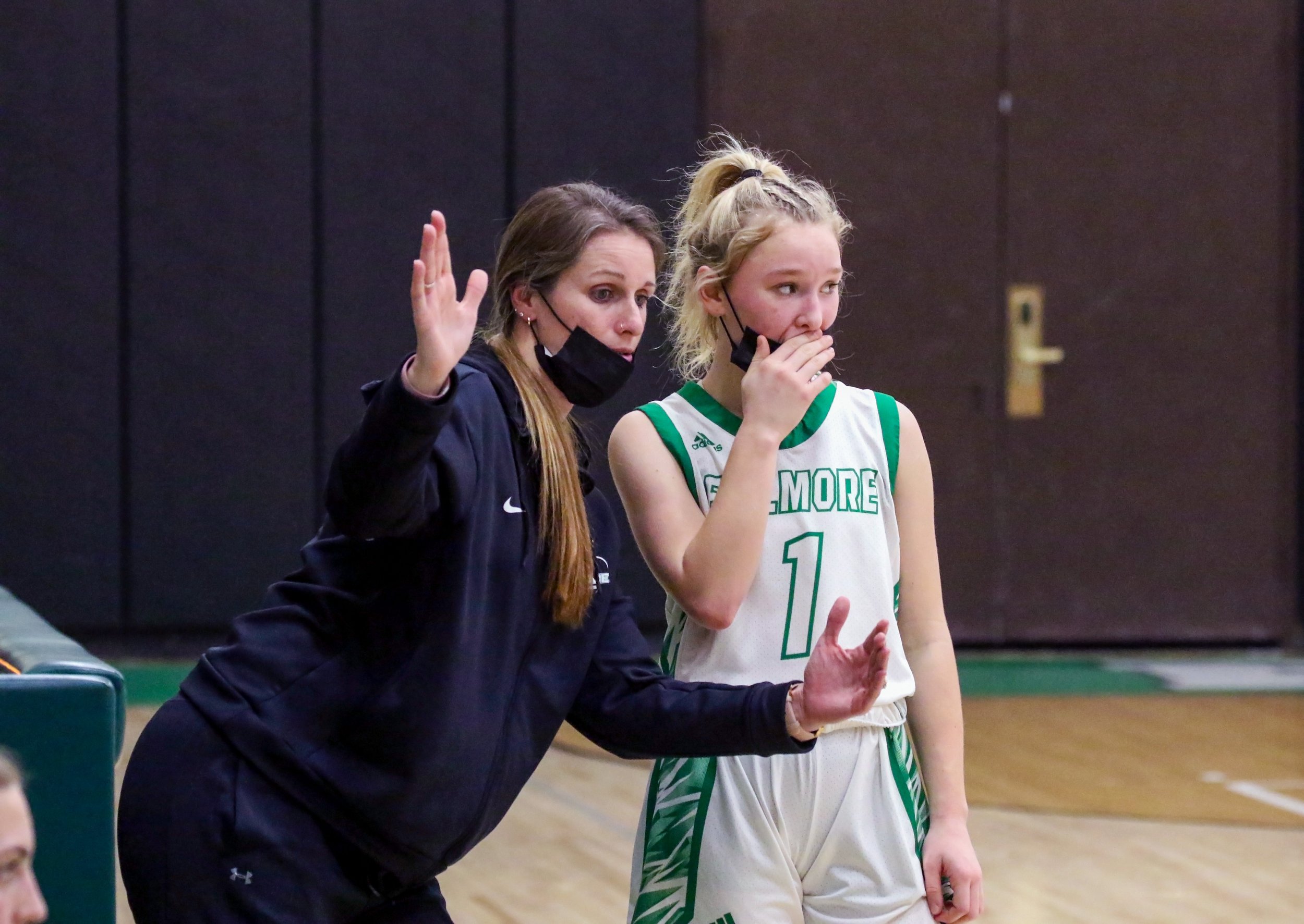  Fillmore assistant coach Alicia Mucher, left, talks with sophomore Hope Russell (1) during a break in the action of Wednesday night’s home contest against C.G. Finney, in Fillmore. [Chris Brooks/WellsvilleSports.com] 