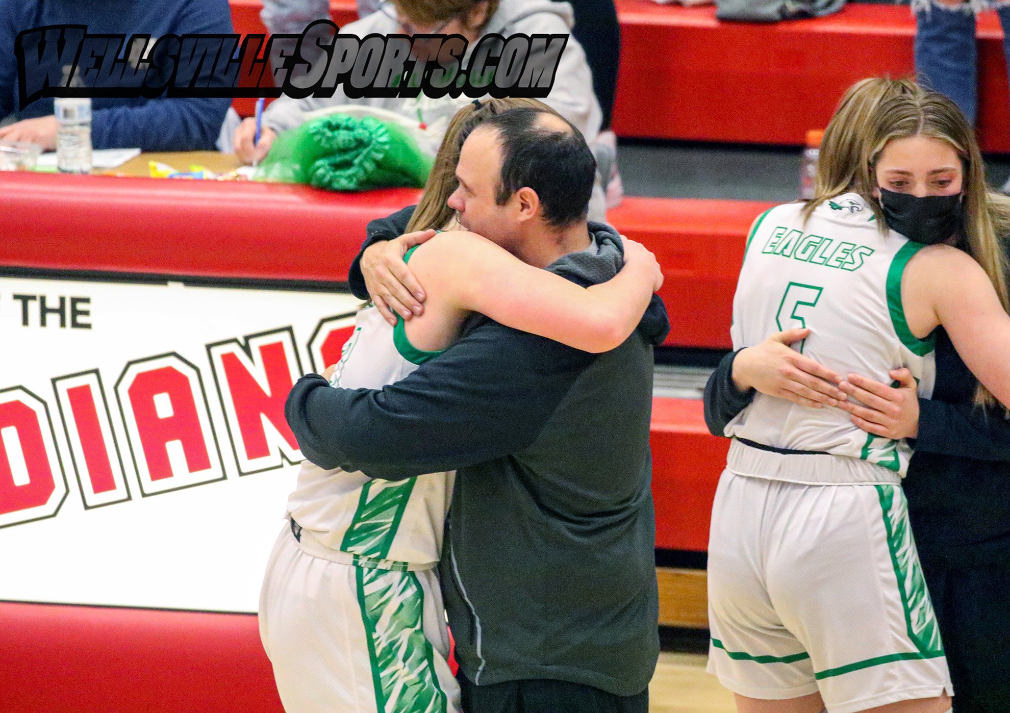  Fillmore head coach Tom Parks, middle, shares a long embrace with his Senior, Emma Cole, (3) after the team fell to eventual Class D1 Champion Notre Dame-Batavia on Friday in the Class D1 Finals at Letchworth. The Lady Eagles wrap up an amazing 2021
