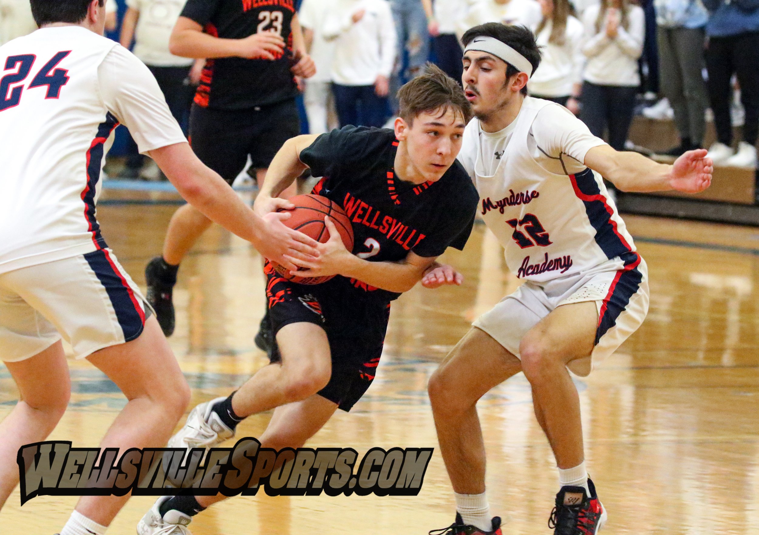  Wellsville junior Cody Costello (2) drives toward the basket, splitting the Mynderse defense on his way in on the attack, during Saturday afternoon’s Class B2 Finals in Webster. [Chris Brooks/WellsvilleSports.com] 