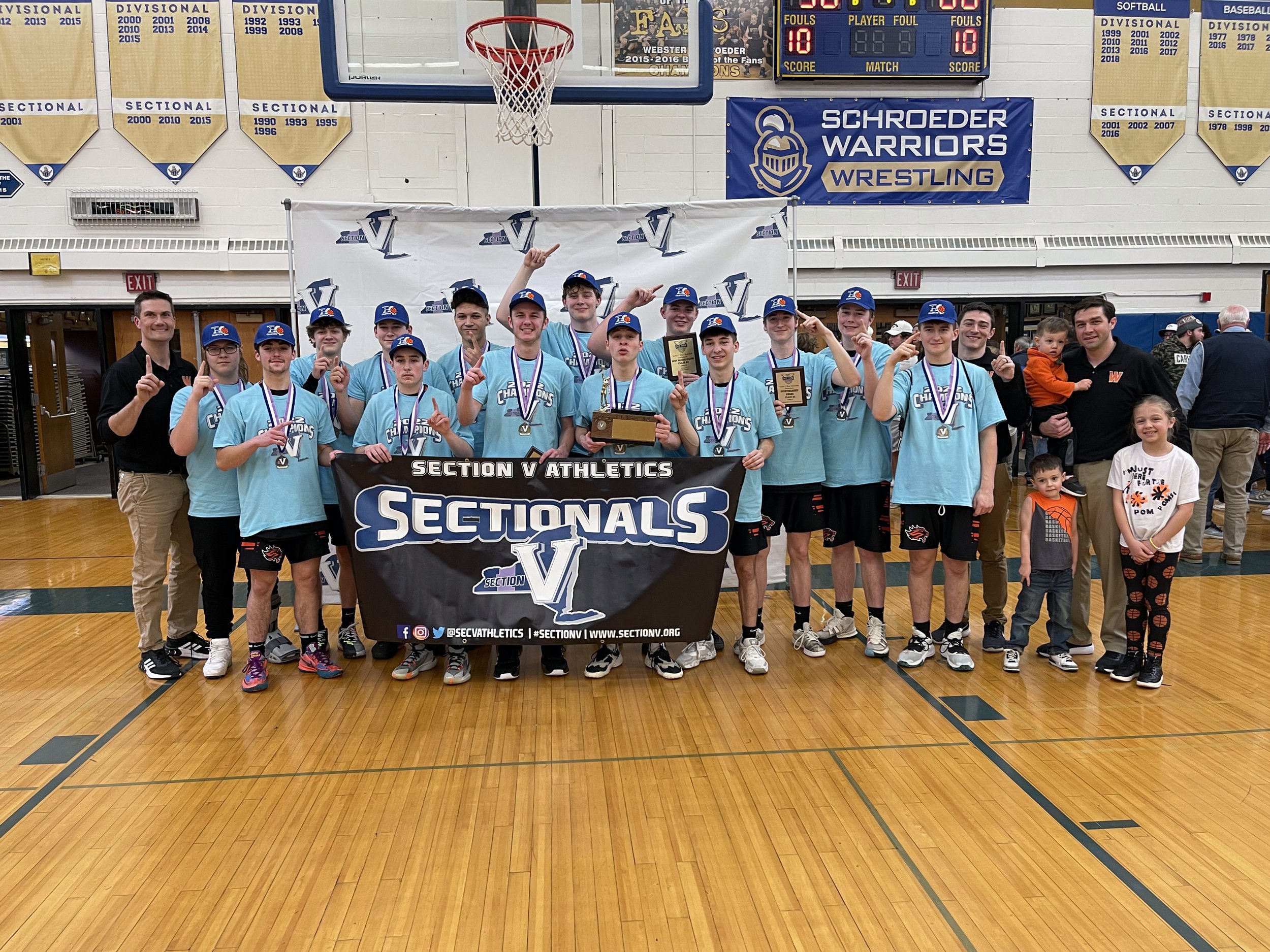  The Wellsville Lions come together for a team photo with their newly-captured Class B2 Championship brick, after they defeated the Mynderse Blue Devils by a 66-58 count on Saturday at Webster Schroeder. [Chris Brooks/WellsvilleSports.com] 