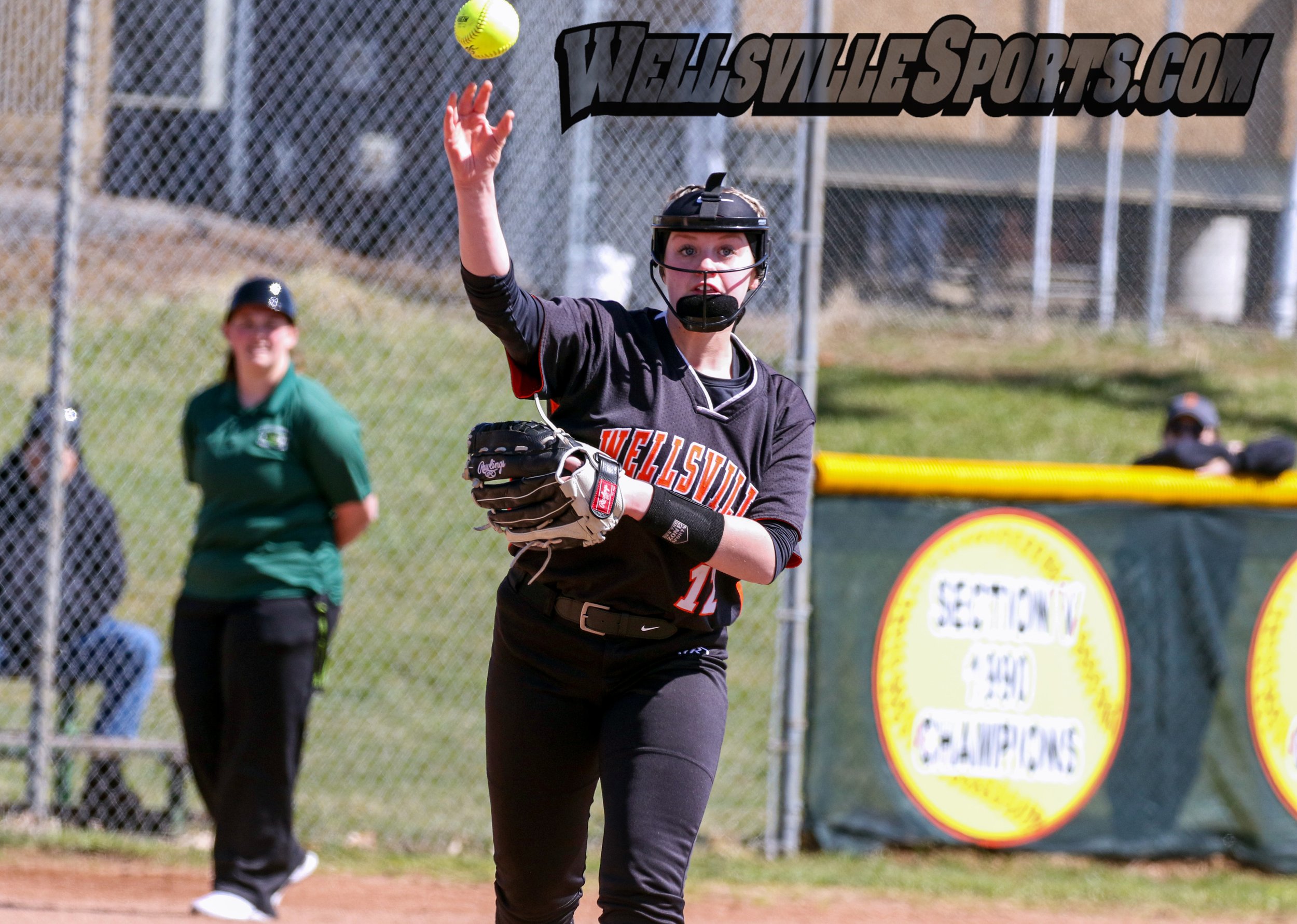  Wellsville sophomore Marissa Ordway (12) delivers a throw to first for the out during Saturday afternoon’s home opener against Allegany-Limestone at Tullar Field in Wellsville. [Chris Brooks/WellsvilleSports.com] 