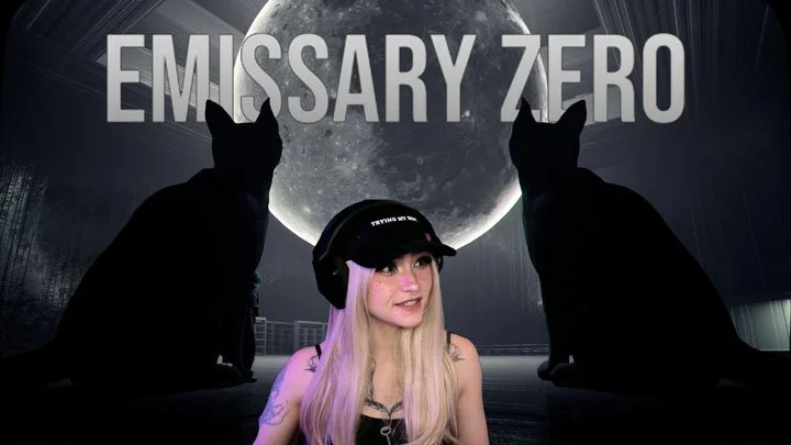 A woman with long blonde hair wearing a black cap and headphones, flanked by two black cats, with a large full moon and the words "EMISSARY ZERO" in the background.
