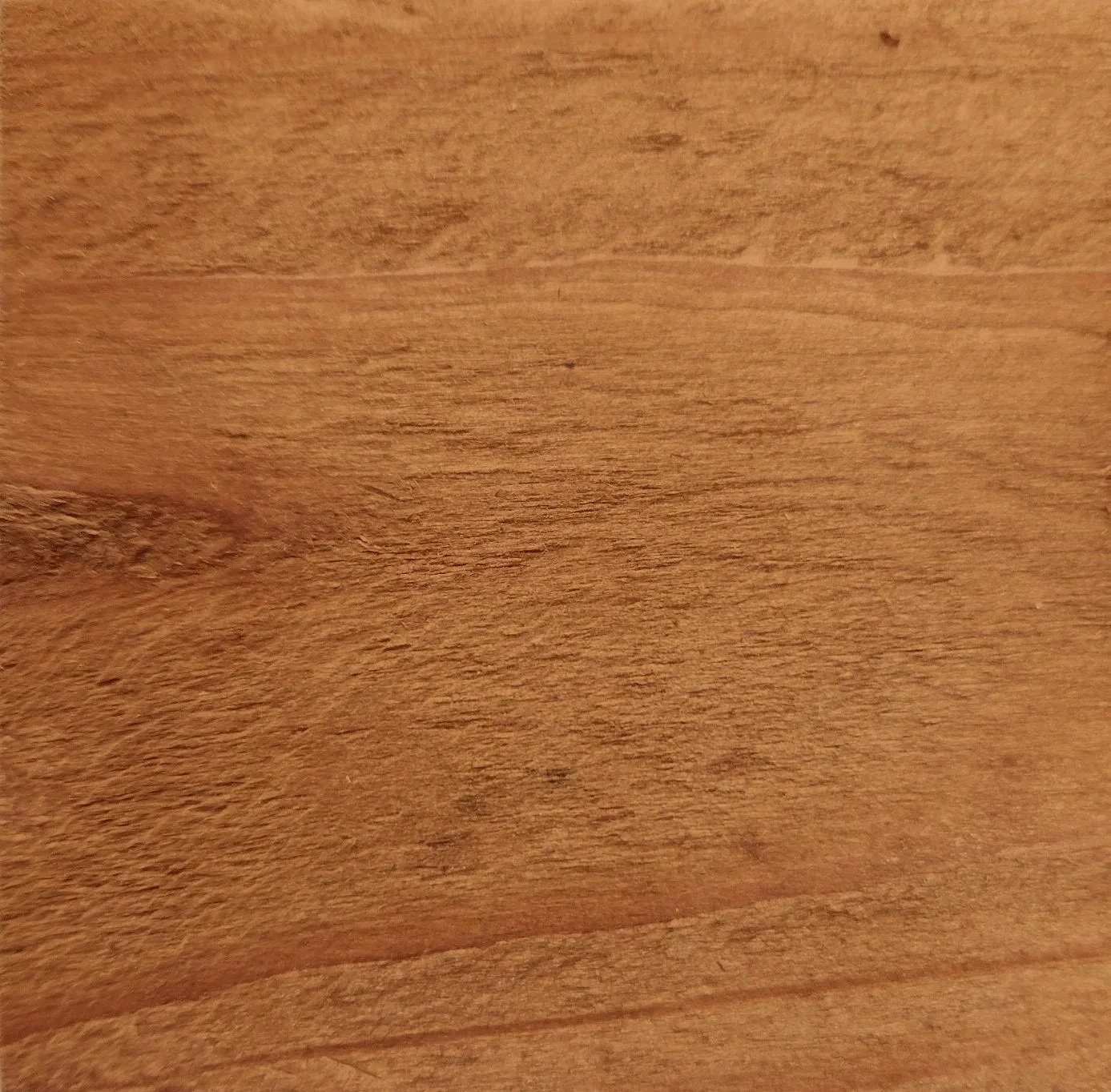 Close-up of a wooden surface with a natural grain pattern.