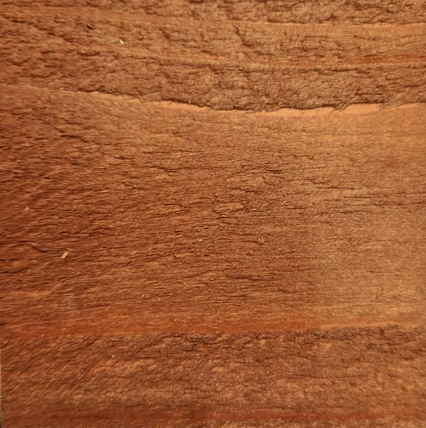 Close-up of a wooden surface with visible grain and texture.