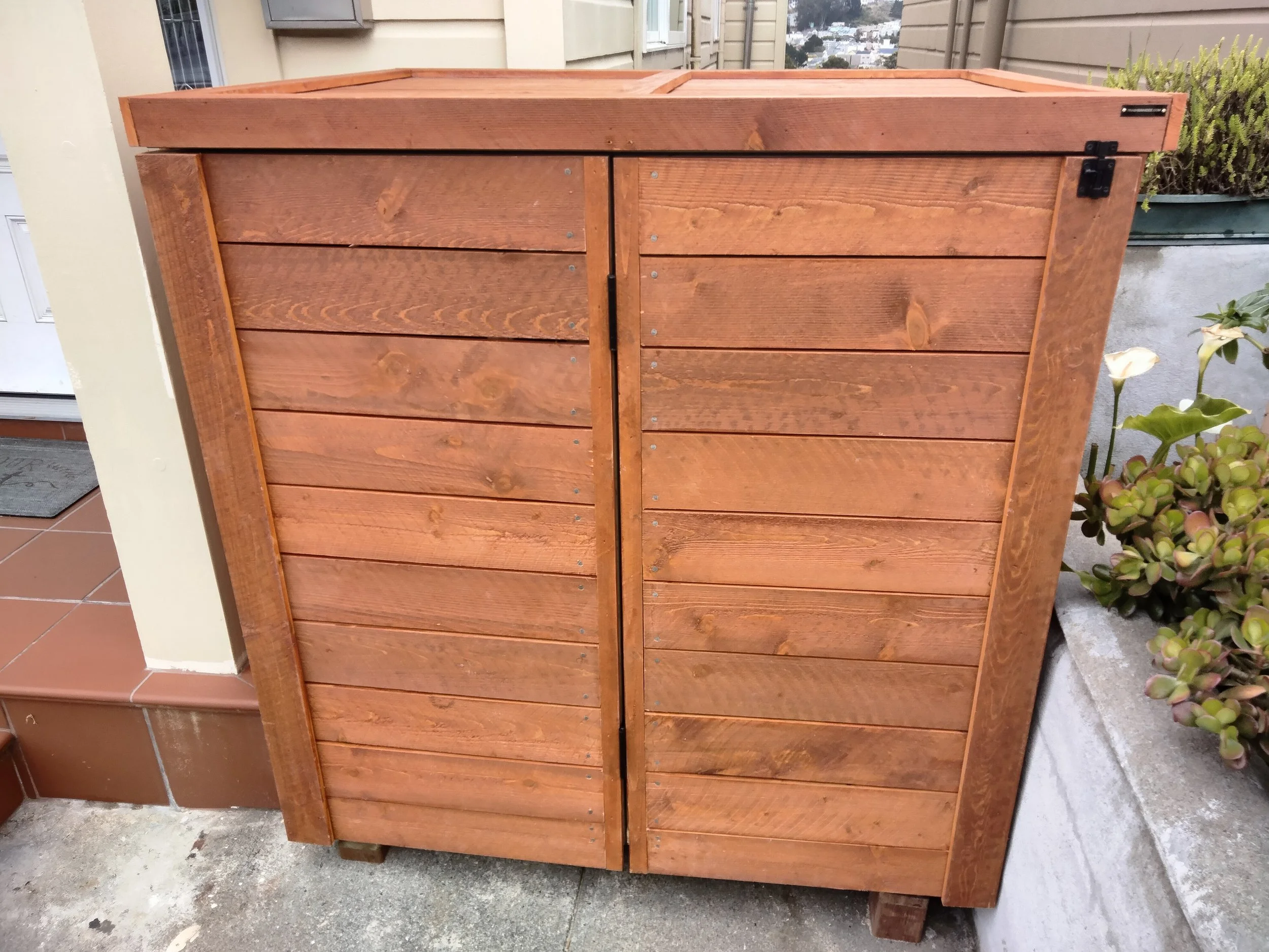 FRONT ENTRY HIDEE  Size: 32-64 GALLON (CUSTOM ORDER)  Siding: REDWOOD  Finish: STAINED  Gas Springs: STEEL  Hardware:  MATTE BLACK STAINLESS STEEL
