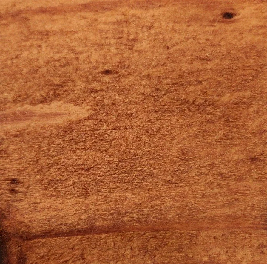 Close-up of a textured wooden surface with natural grain and knots.