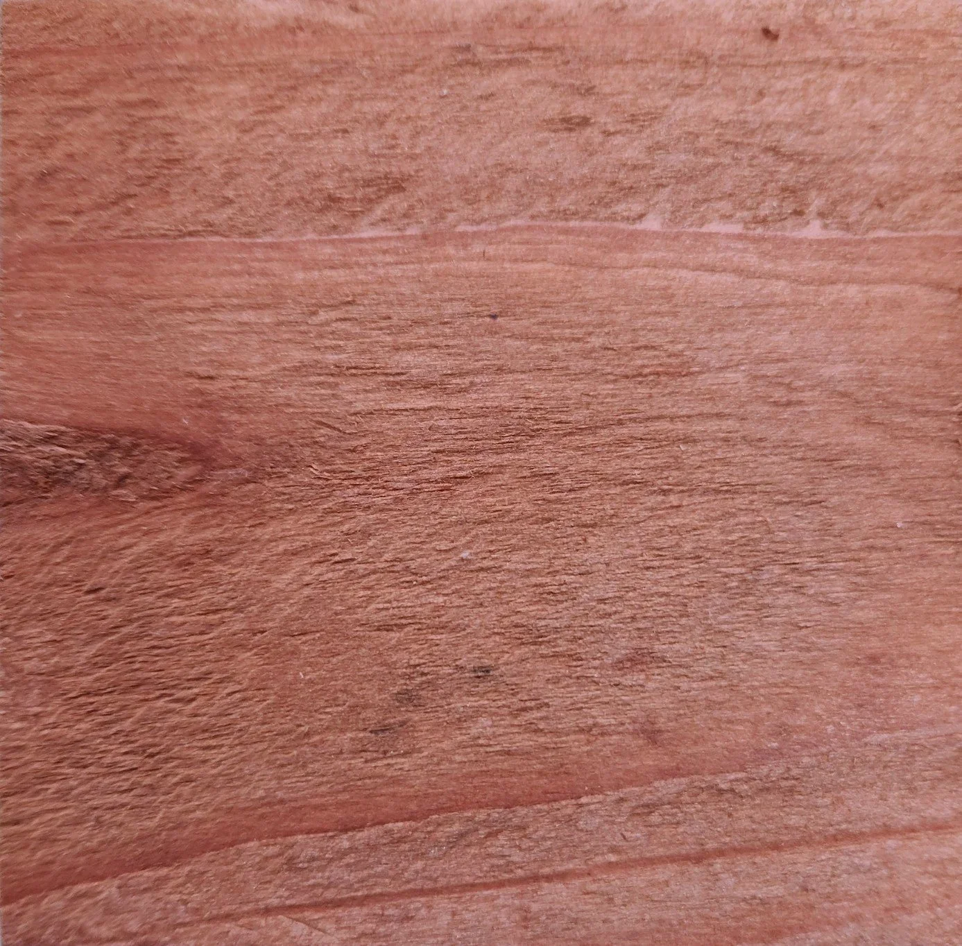 Close-up of a wooden surface with visible grain and texture.