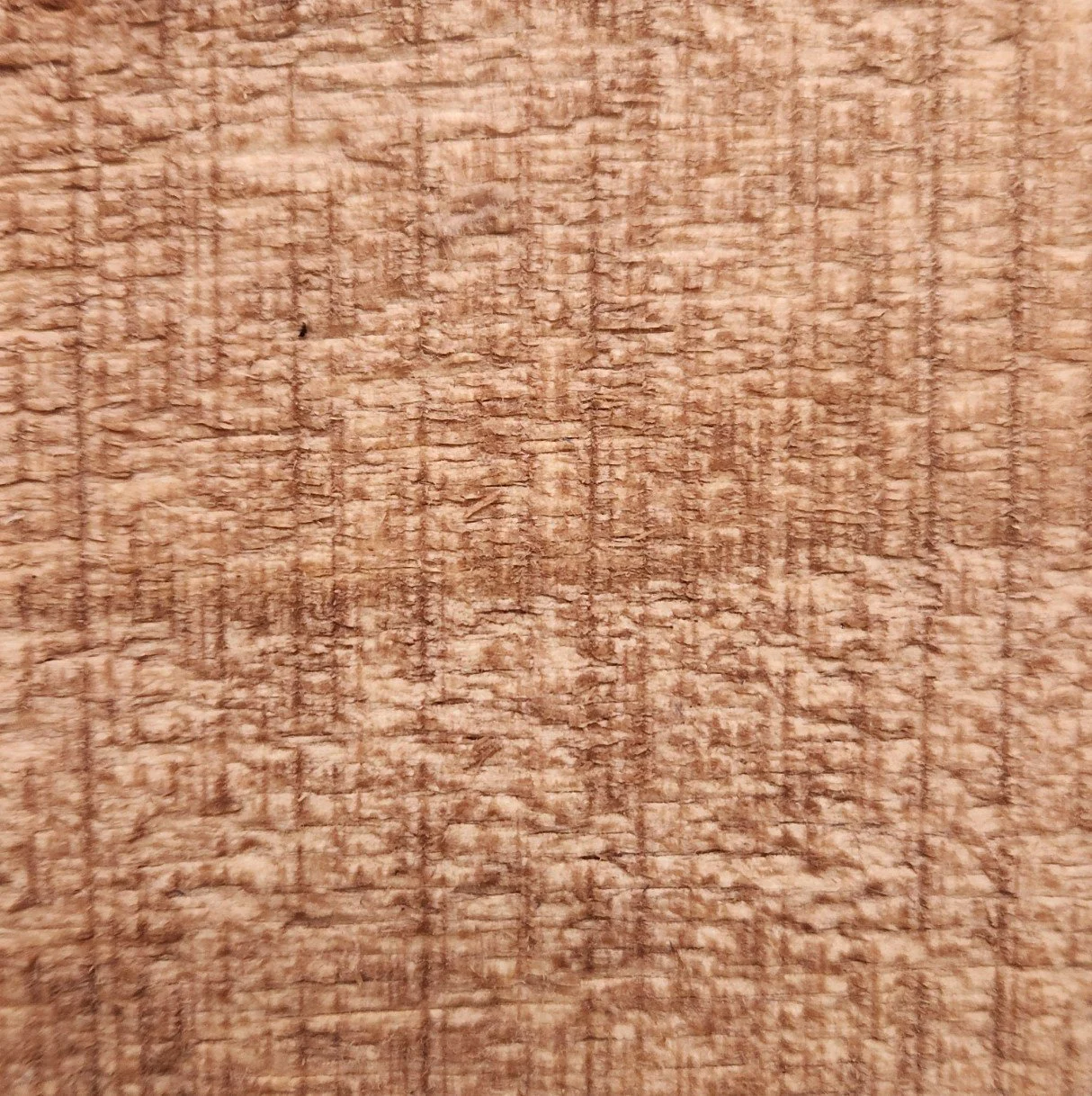 Close-up of a wooden surface with visible grain and texture.