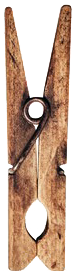 Clothespin with a metal clip attached to a piece of string, hanging on a wooden surface.