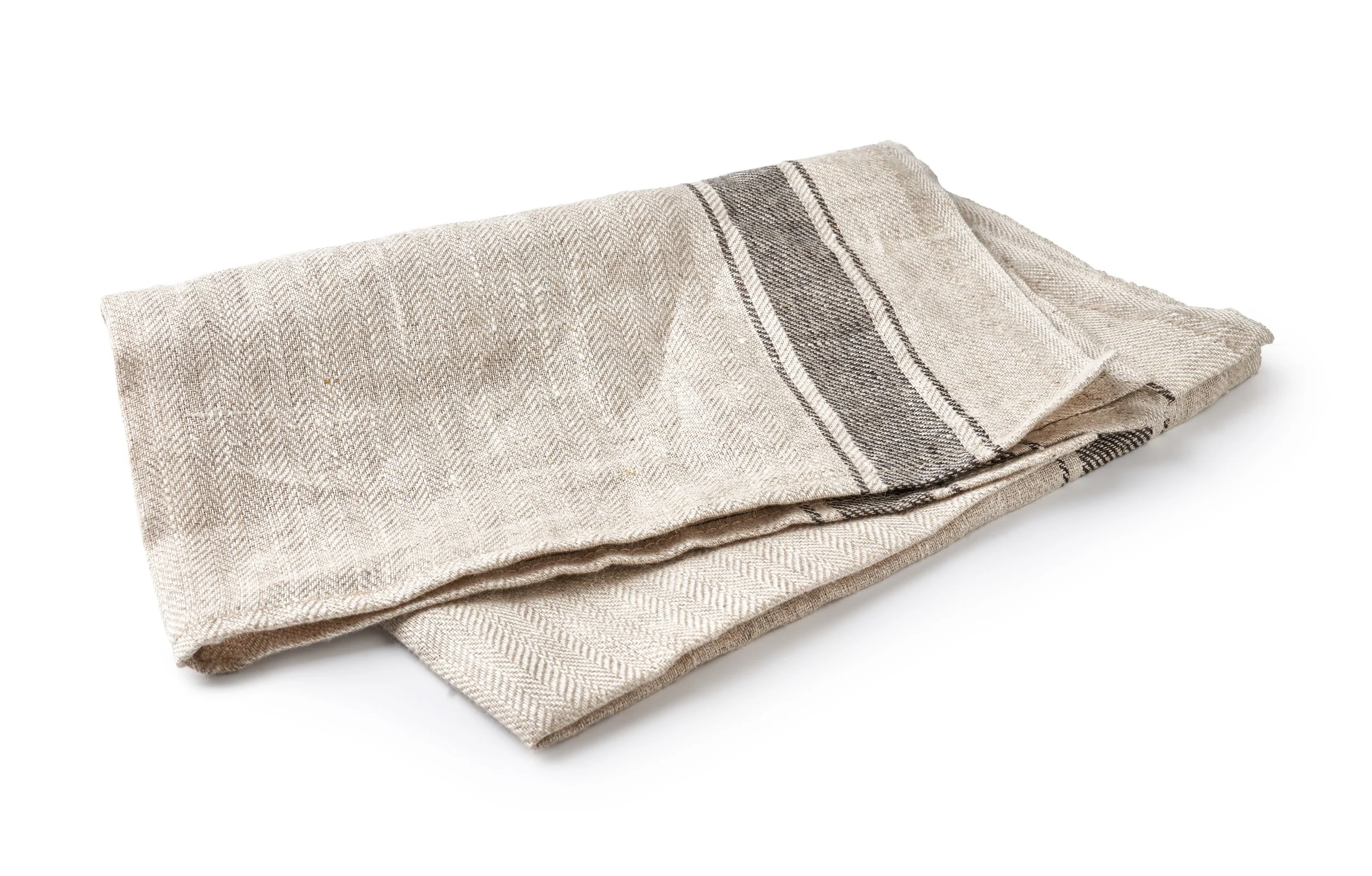 A folded beige linen kitchen towel with dark stripes on a white background.