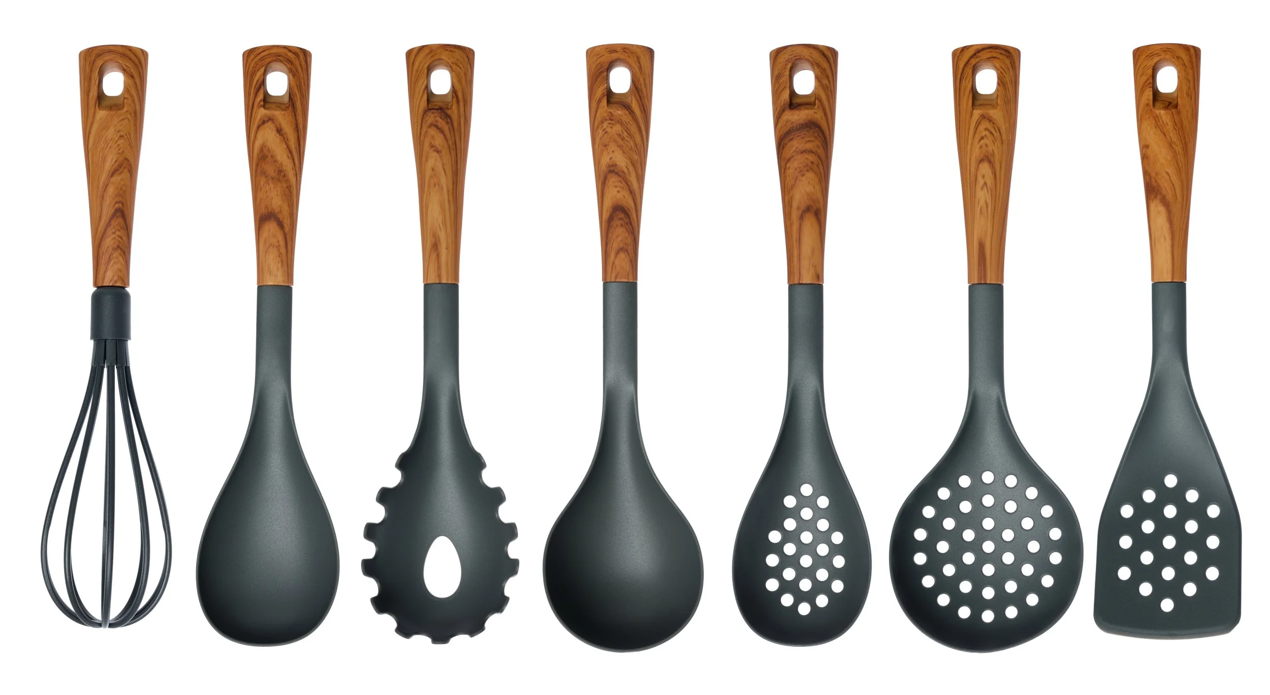 Set of kitchen utensils with black handles and wooden accents, including a whisk, slotted spoon, spatula, and slotted turner, arranged in a row.