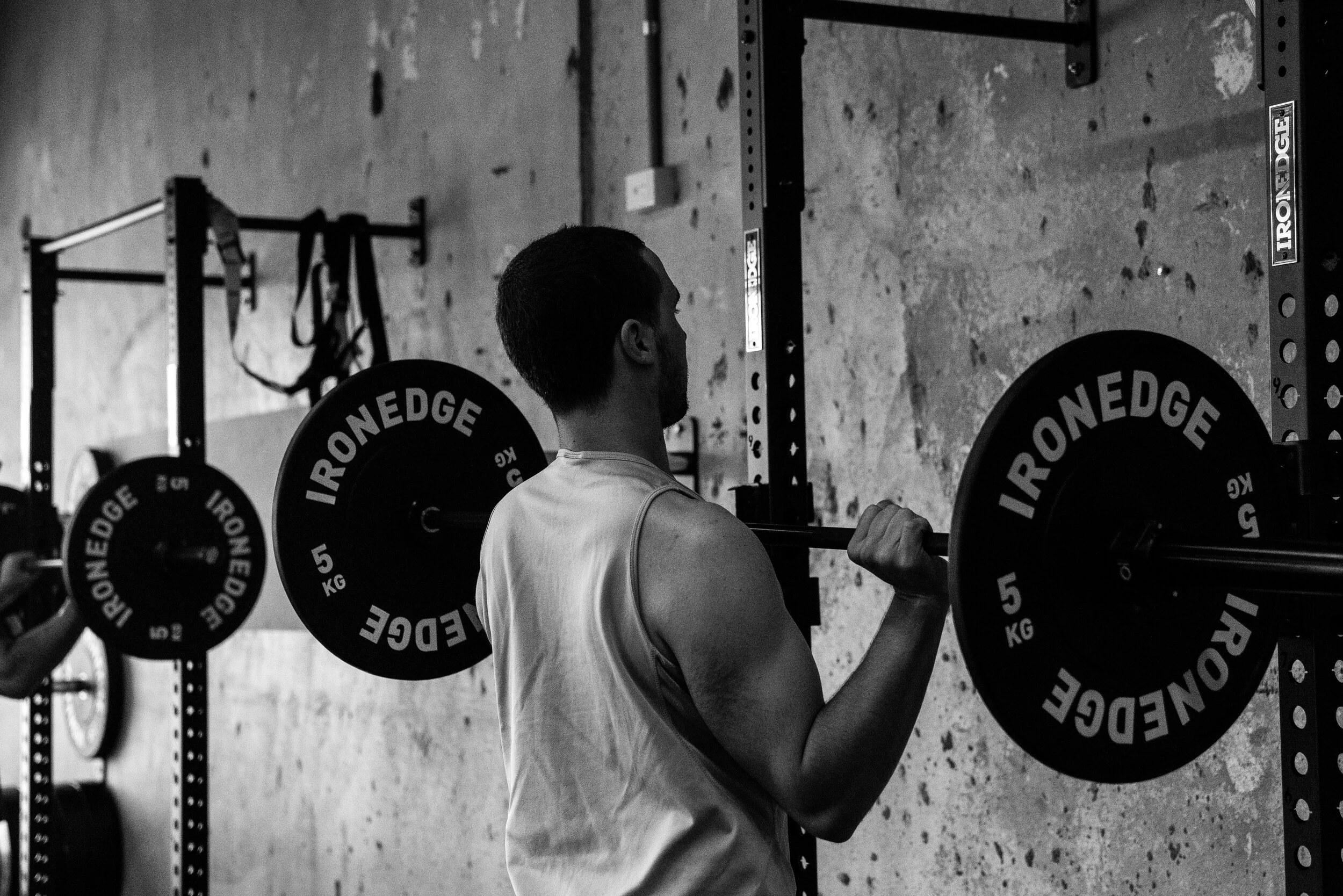 Someone working out in a gym with weights in the strong room class.