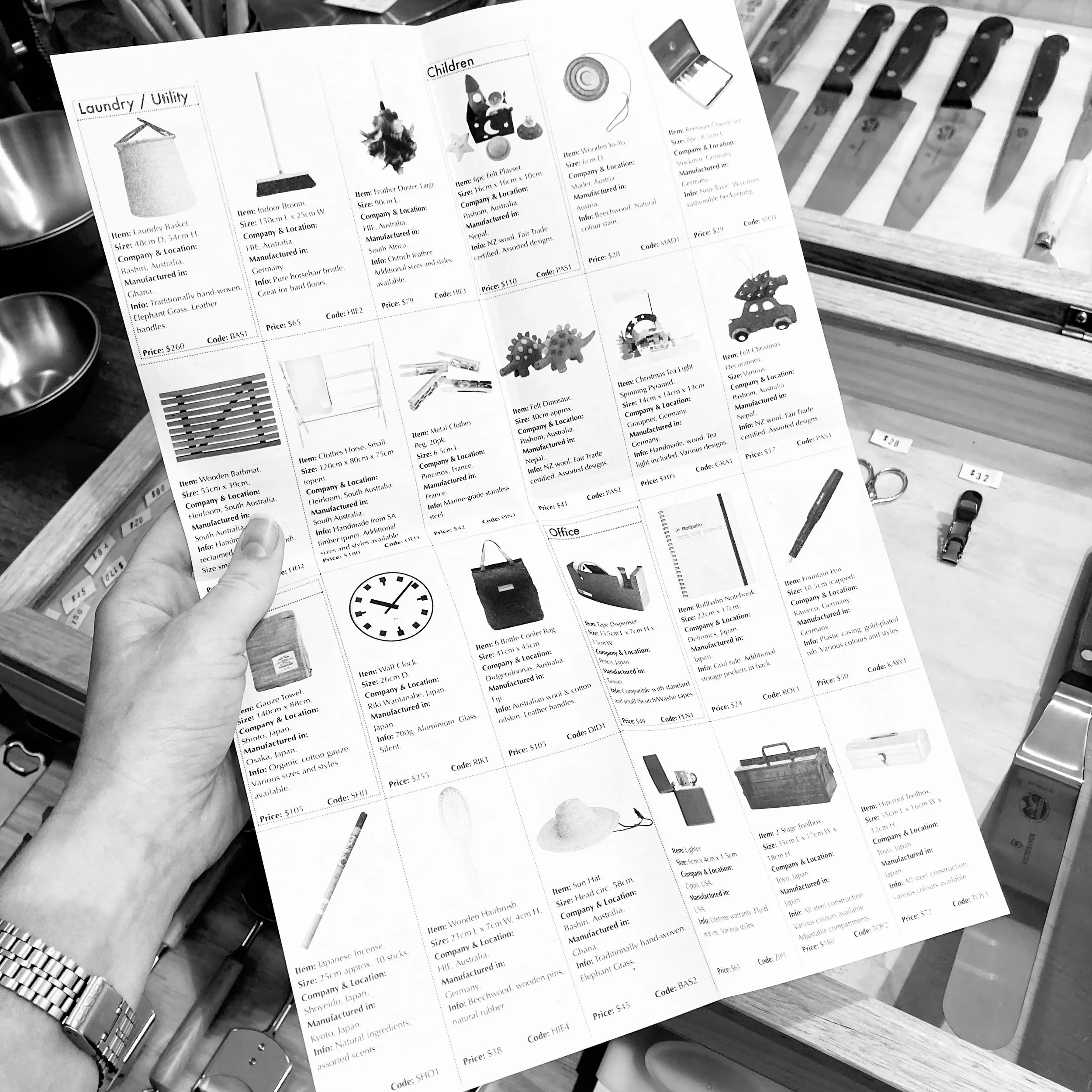 Hand holding paper Heirloom catalogue.