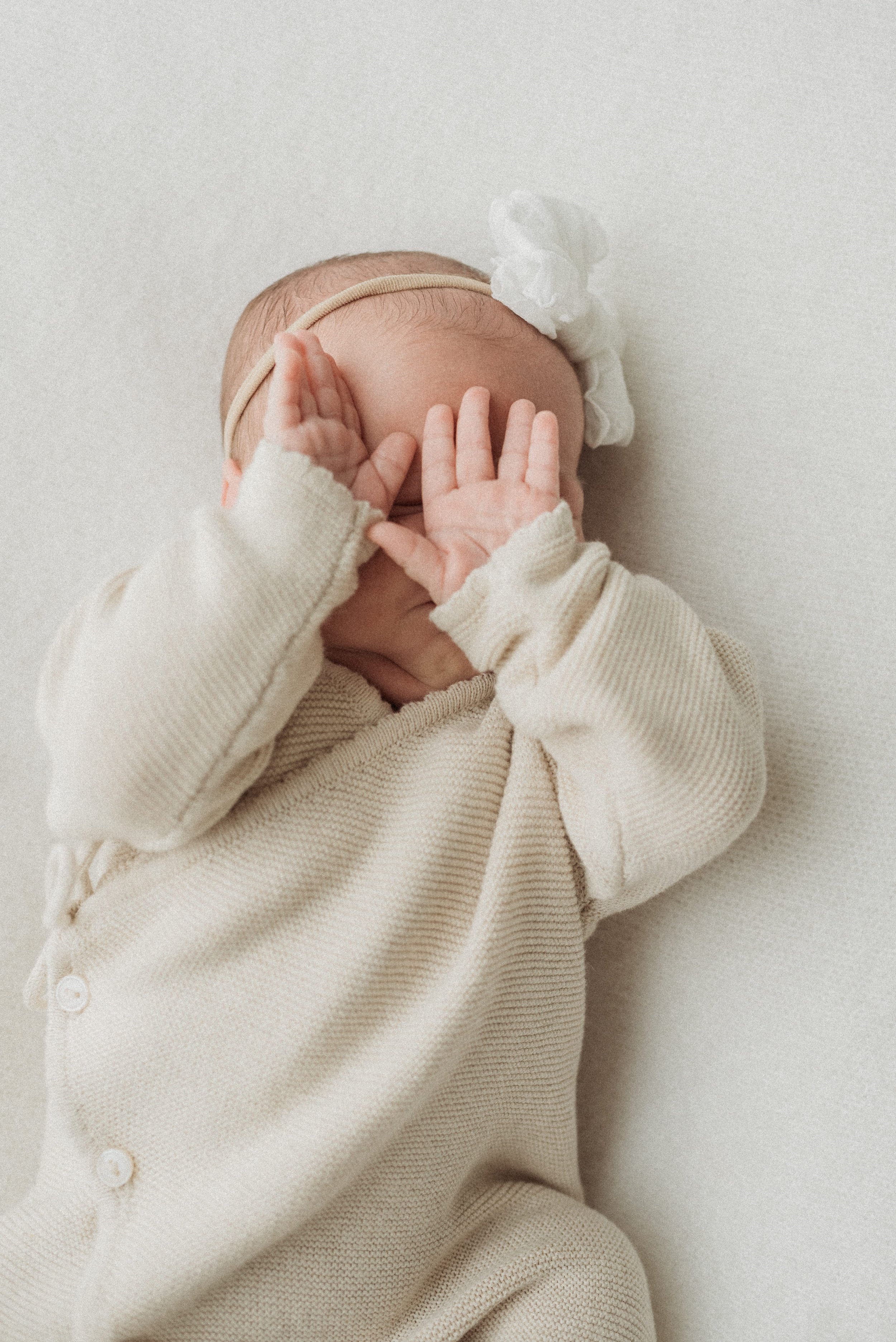 Baby covering face in photo