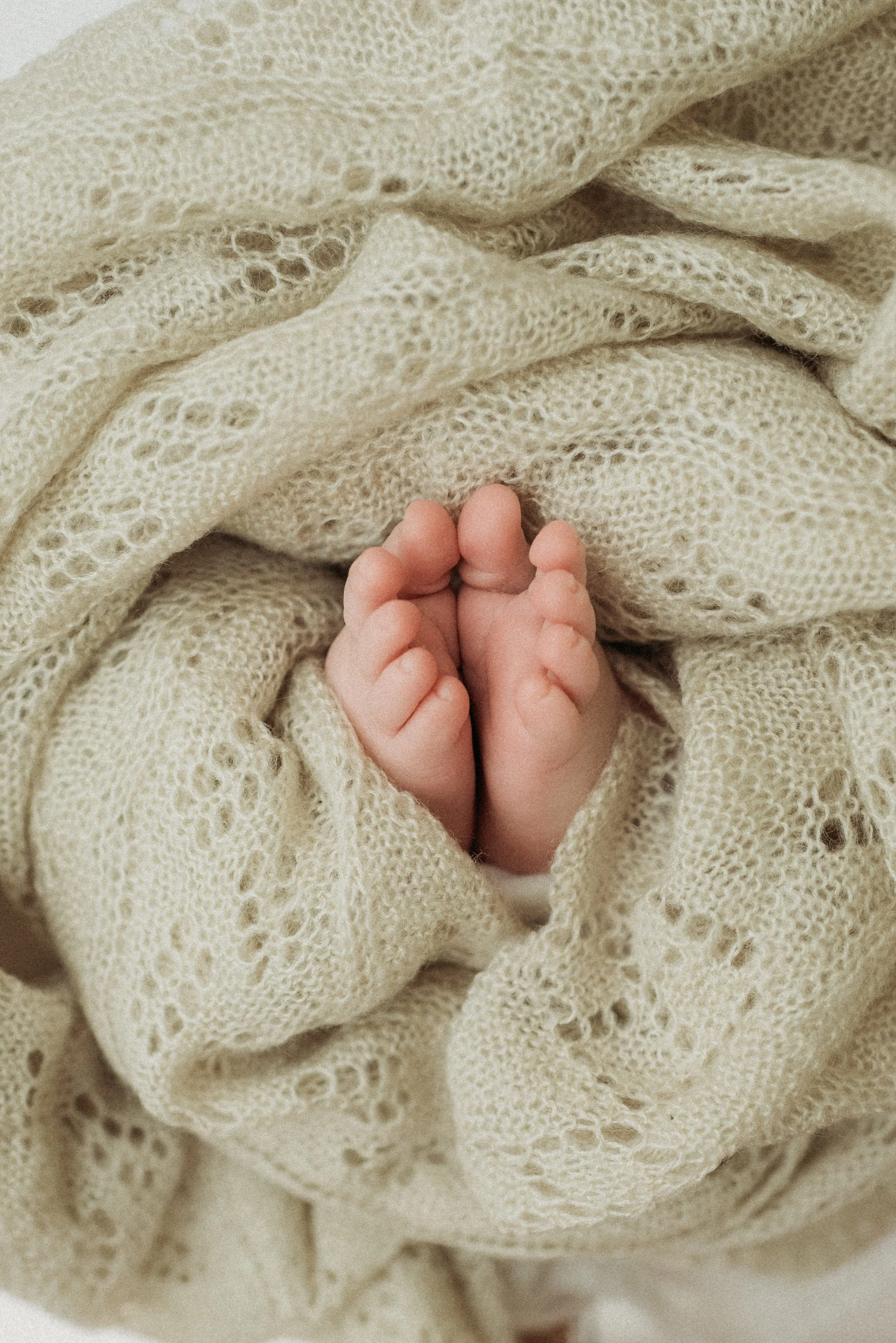 tiny baby toes wrapped in a blanket