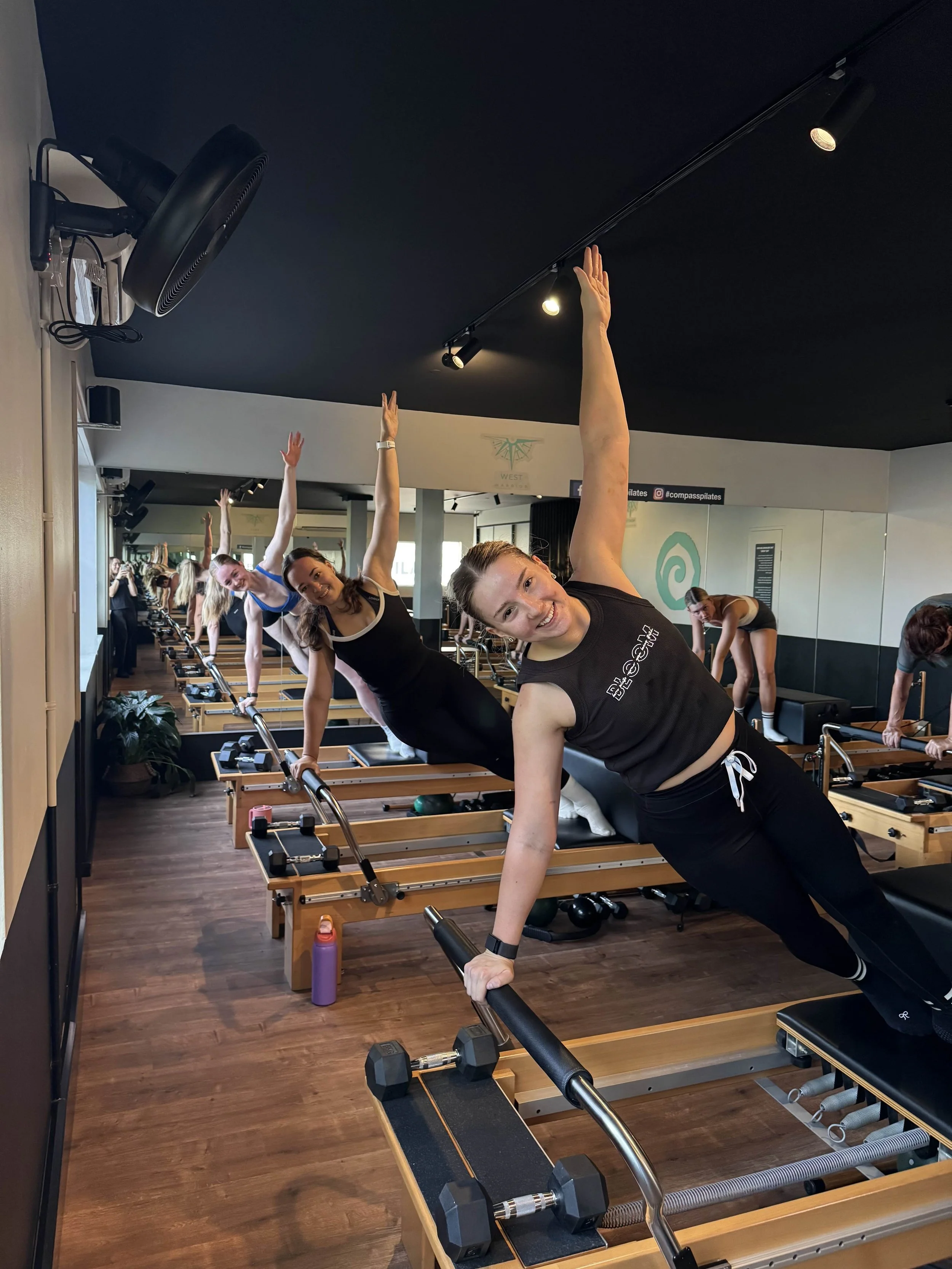 Side plank being performed on a Pilates Reformer